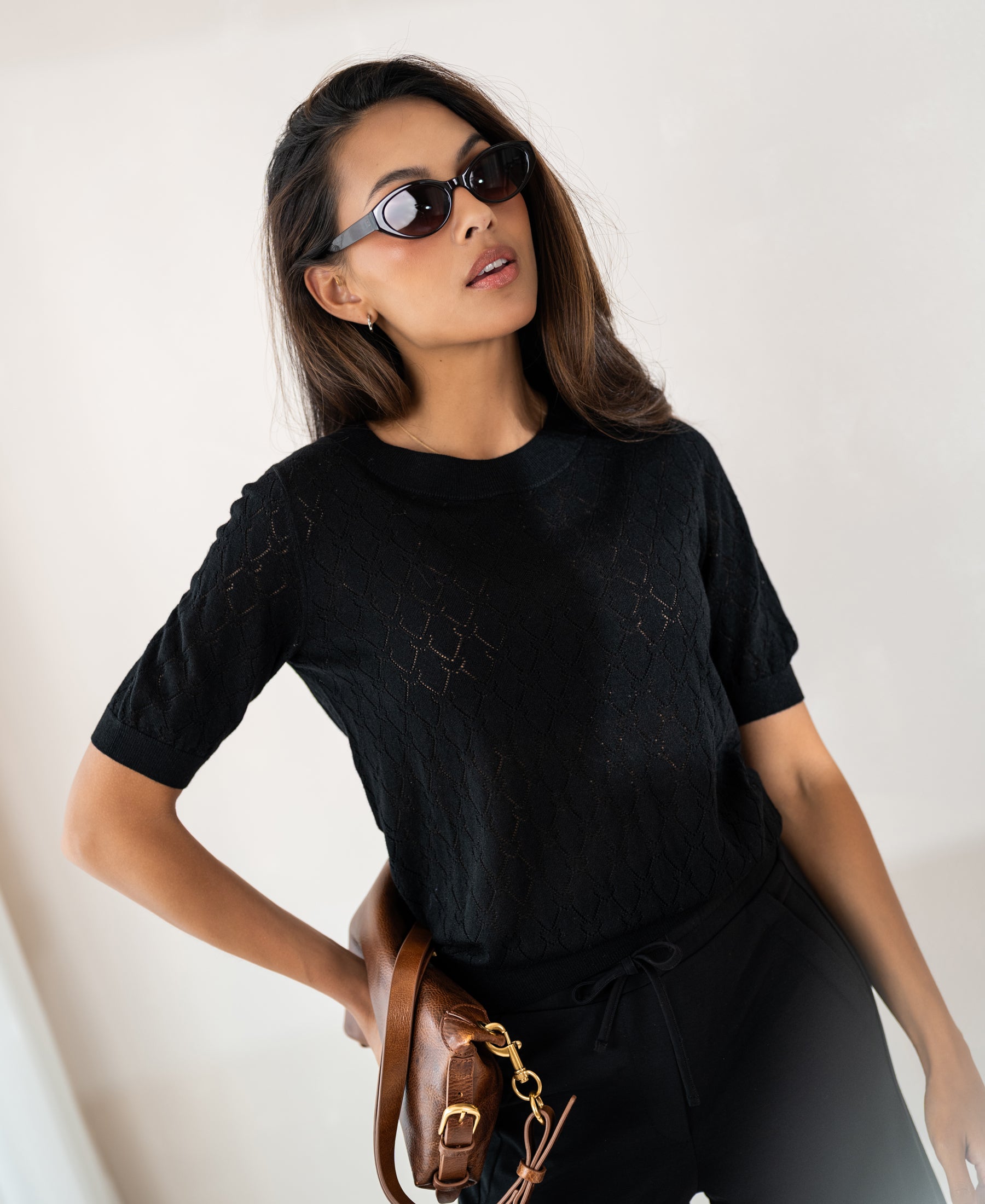 Black sweater with heart pattern, front view.
