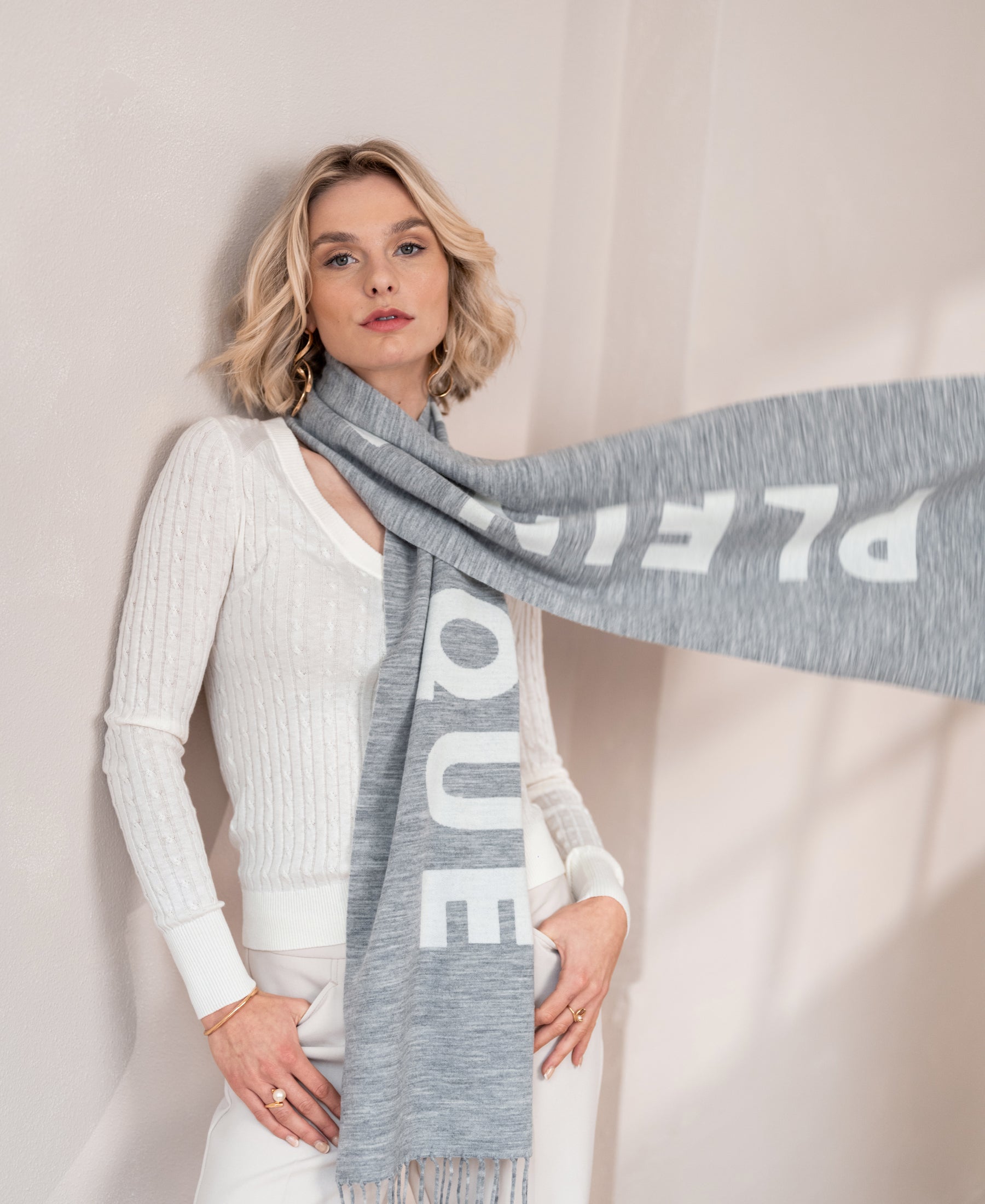 SALE wool scarf in light grey and ivory shown against a light wall.