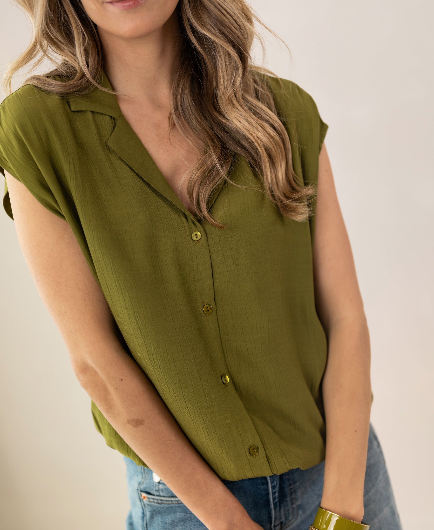 Sleeveless, olive-green LA BIJOU blouse by PLEIN PUBLIQUE against a plain background.