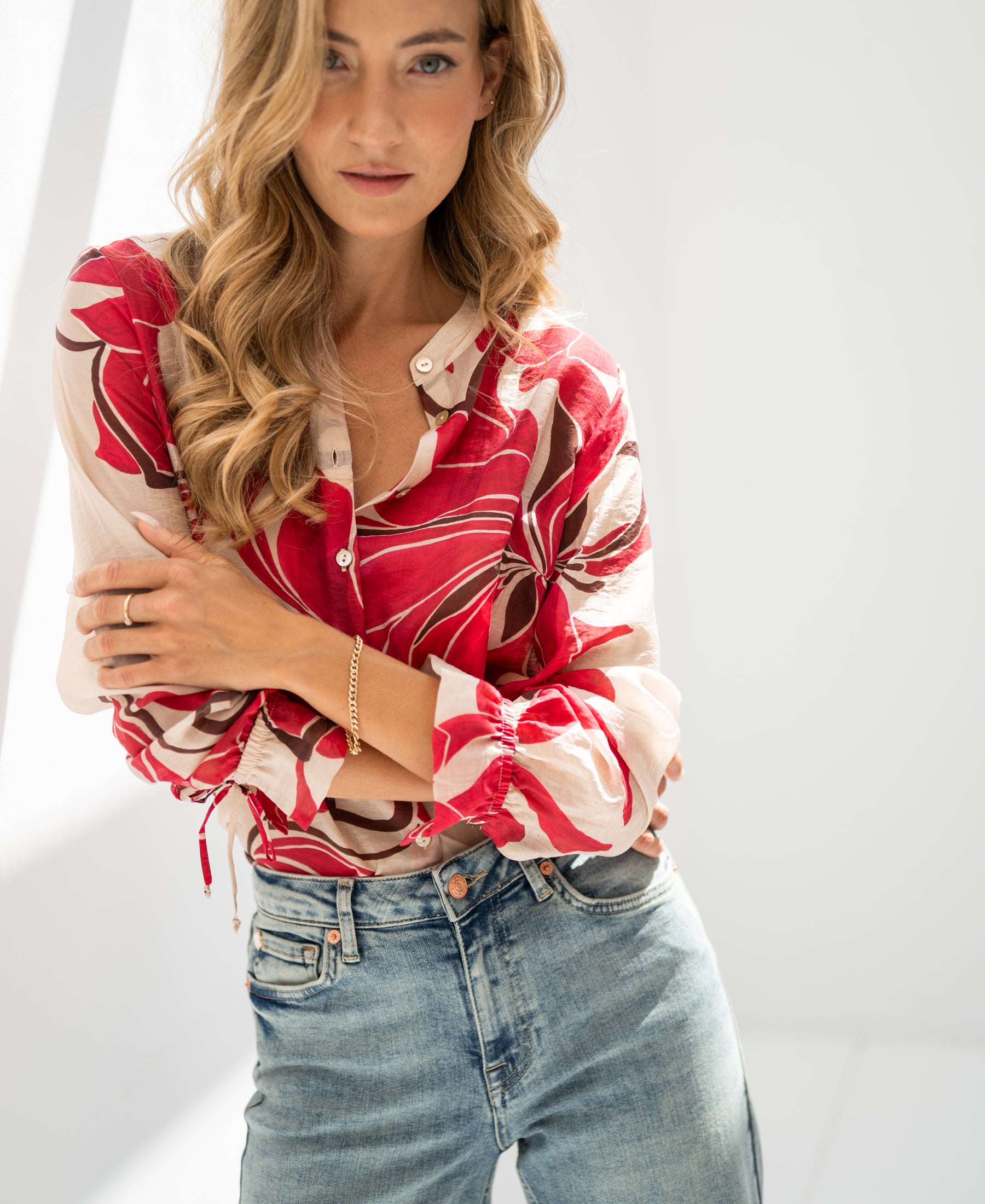 Ruby Red print LA BINOCLE blouse shown in natural light.