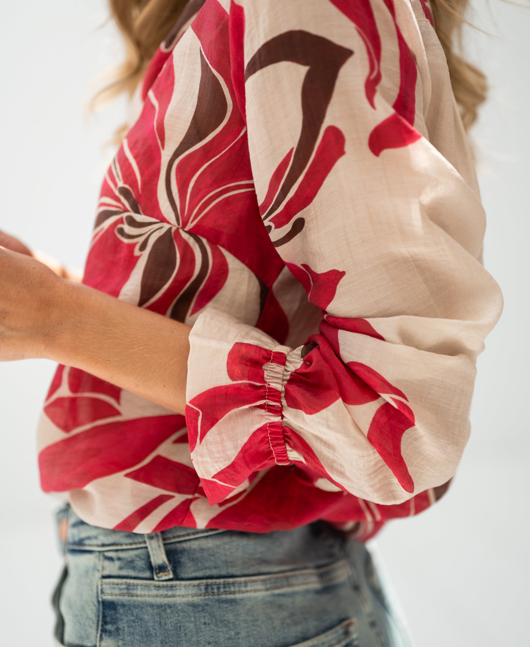 Ruby Red print blouse with rolled sleeves.