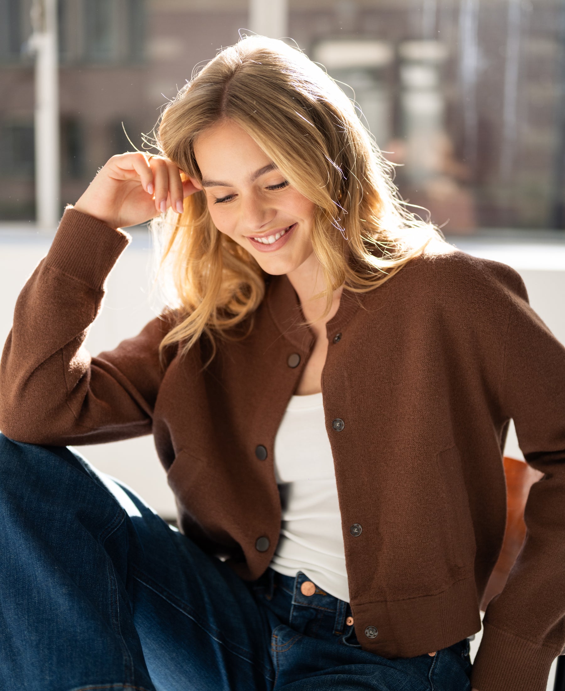 Camel-colored bomber jacket LA BOMBA by PLEIN PUBLIQUE shown indoors in sunlight.