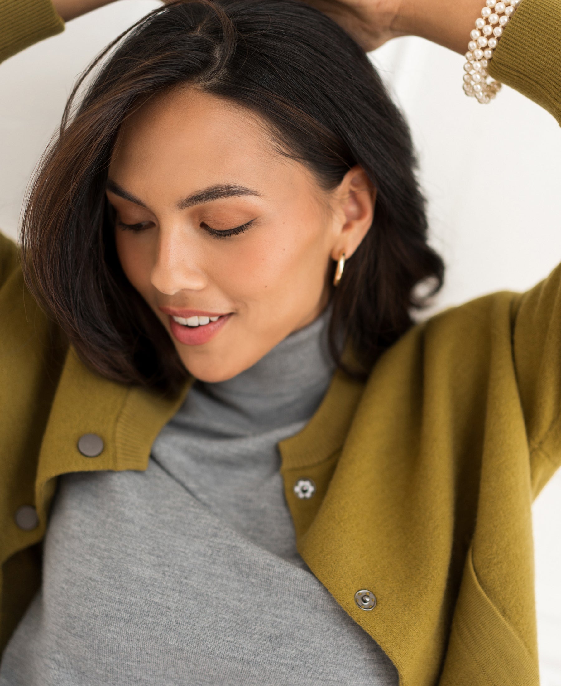 Feather green ribbed turtleneck sweater in cotton, shown on a woman with dark hair.