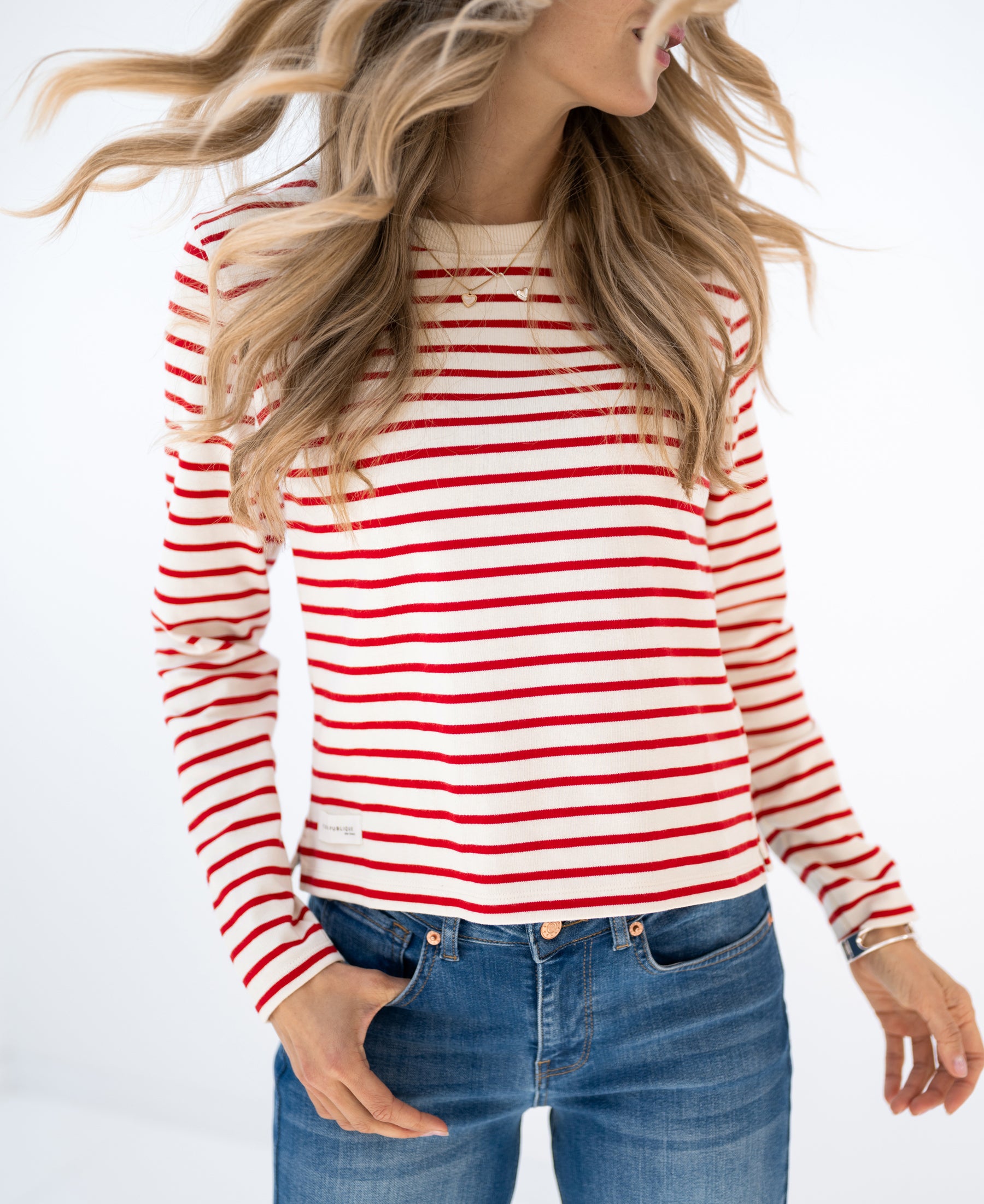PLEIN PUBLIQUE's Breton striped shirt LA BRETONNE in ivory-red, shown on model with wavy blonde hair.