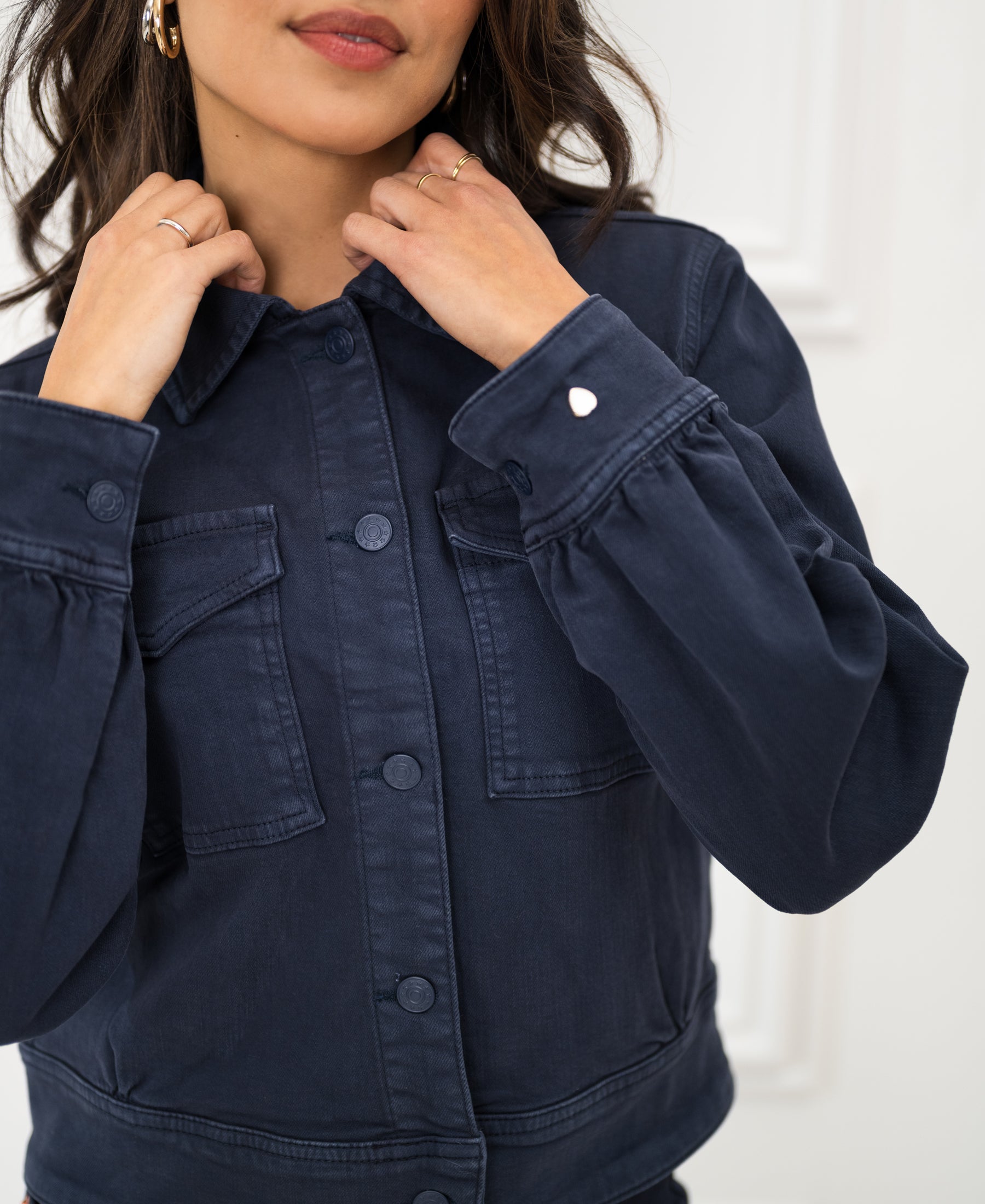 Dark blue PLEIN PUBLIQUE stretch denim jacket "The Callas" against a white background.