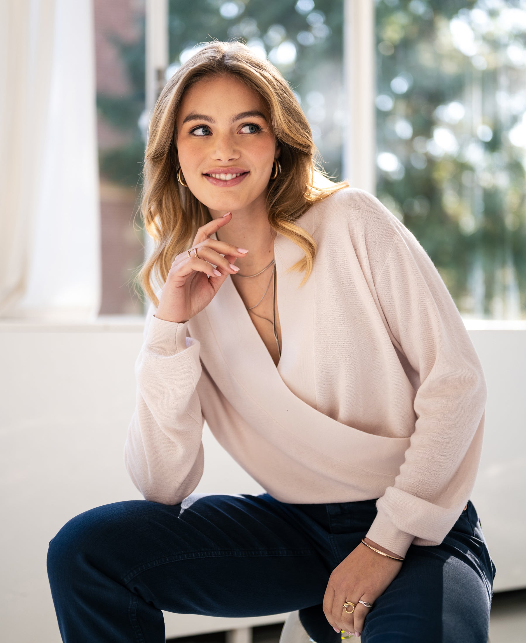 Soft blush wrap sweater by PLEIN PUBLIQUE, LES CINQ style, shown indoors.