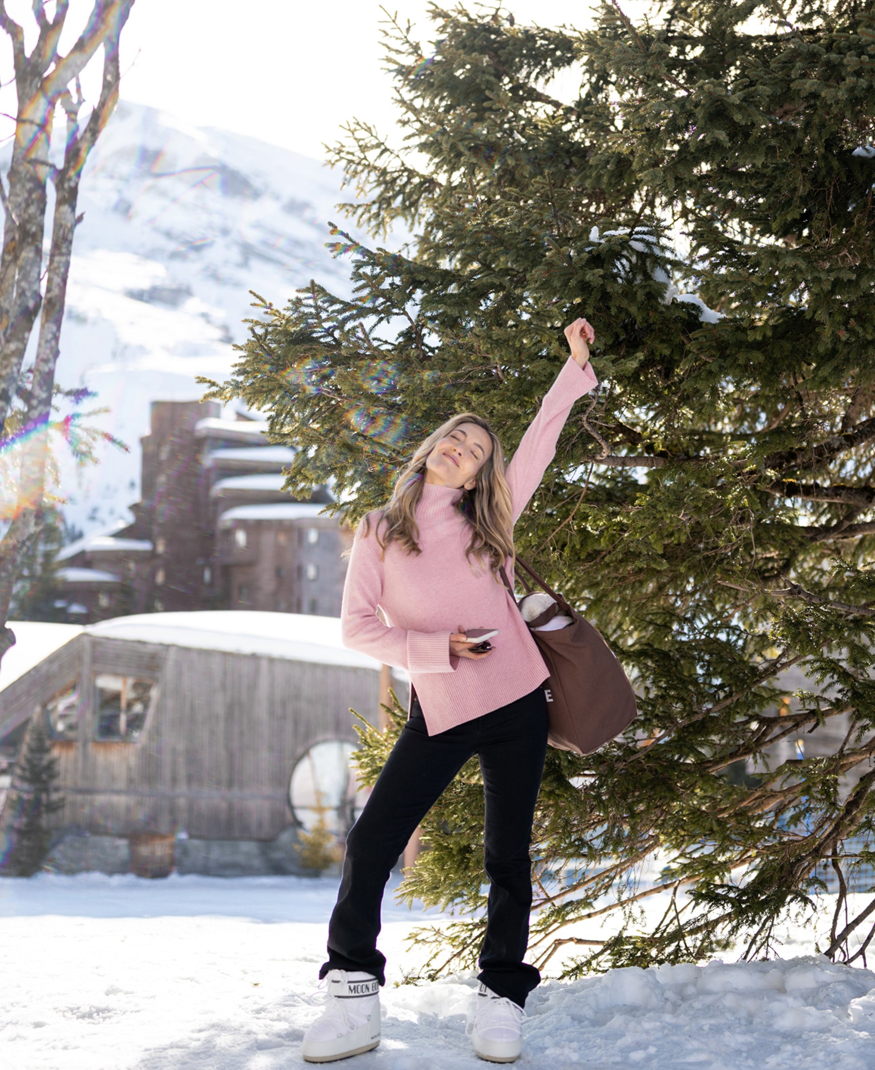 Woman wears a pink LA COZY turtleneck sweater by PLEIN PUBLIQUE.