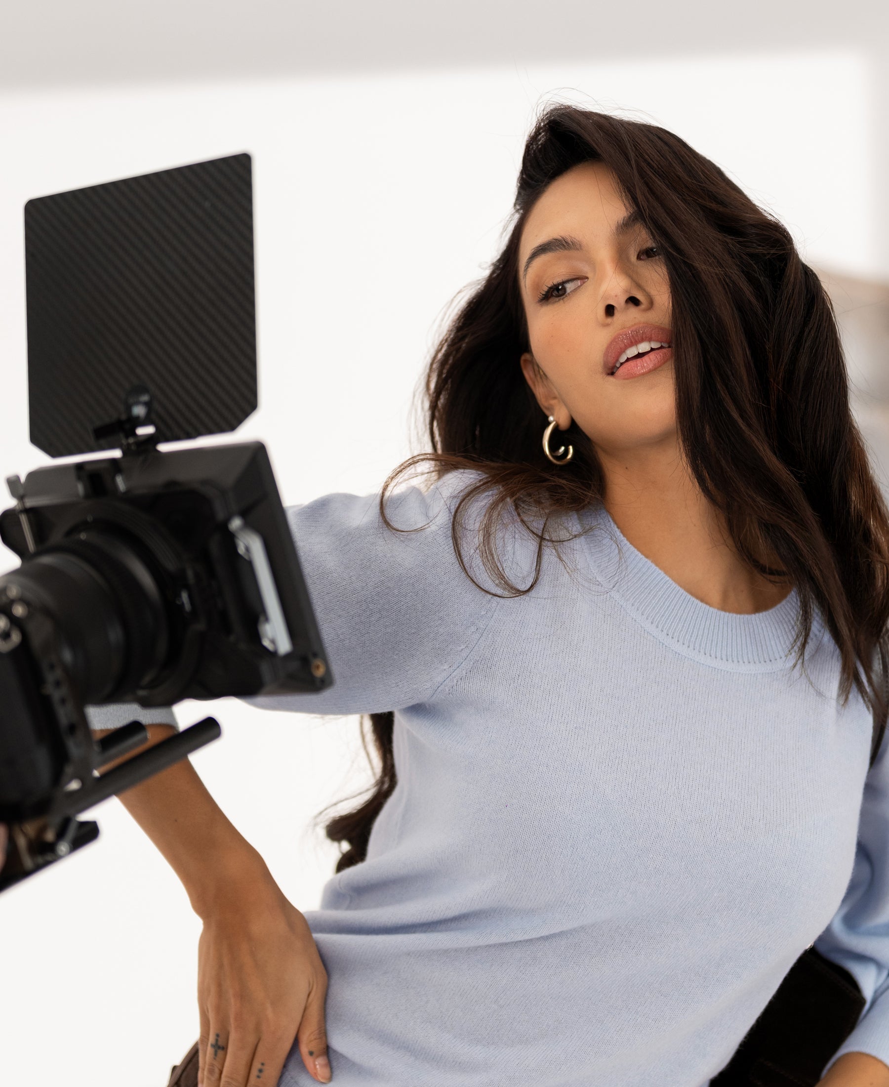 Woman wearing the LE FREJUS Light Blue Merino Wool Sweater from PLEIN PUBLIQUE.