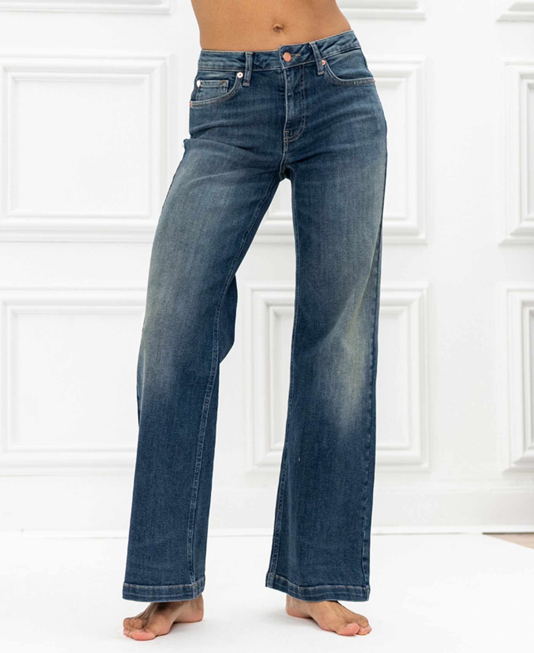 Wide leg jeans in blue vintage wash by Les Deux, shown against a white paneled background.