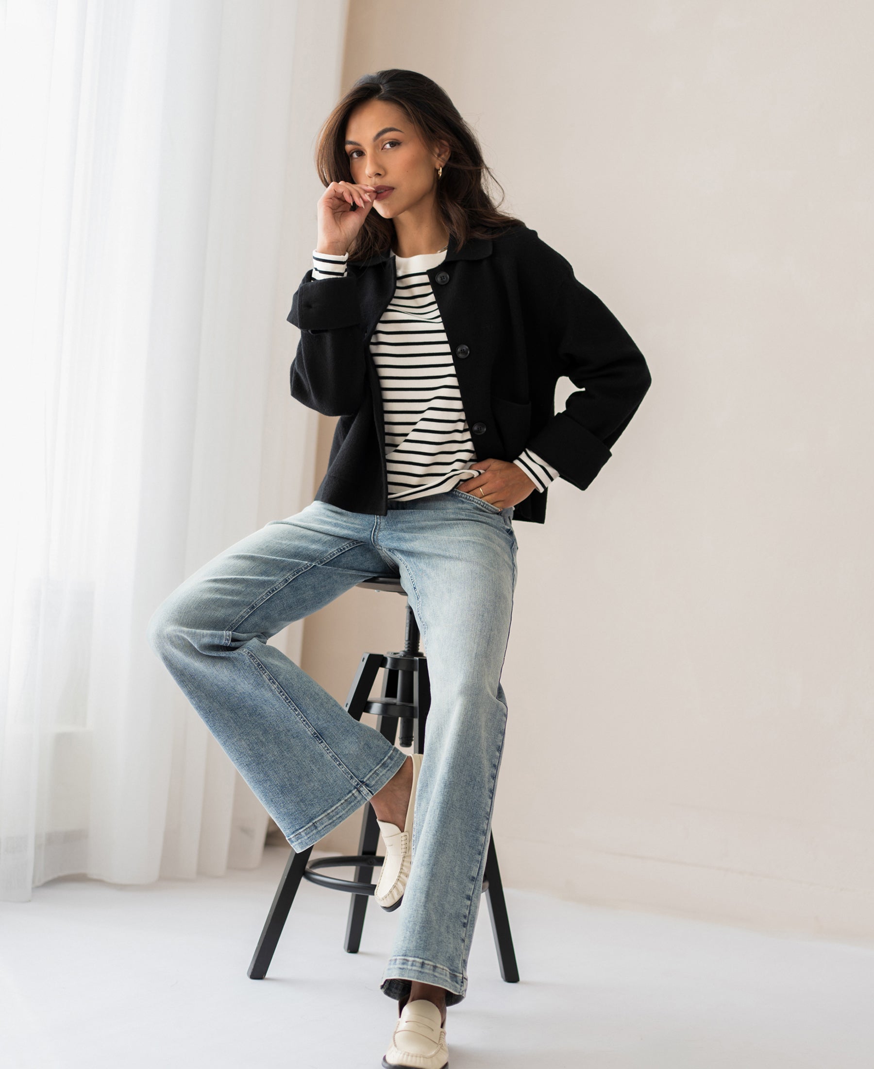 Wide leg jeans by LES DEUX Vintage, shown worn by a model sitting on a stool in a bright room.