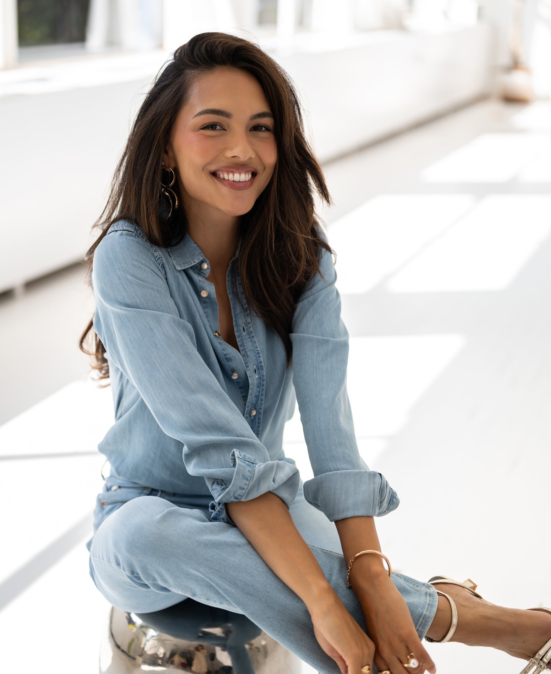 Tencel bleached denim blouse in a bright room.
