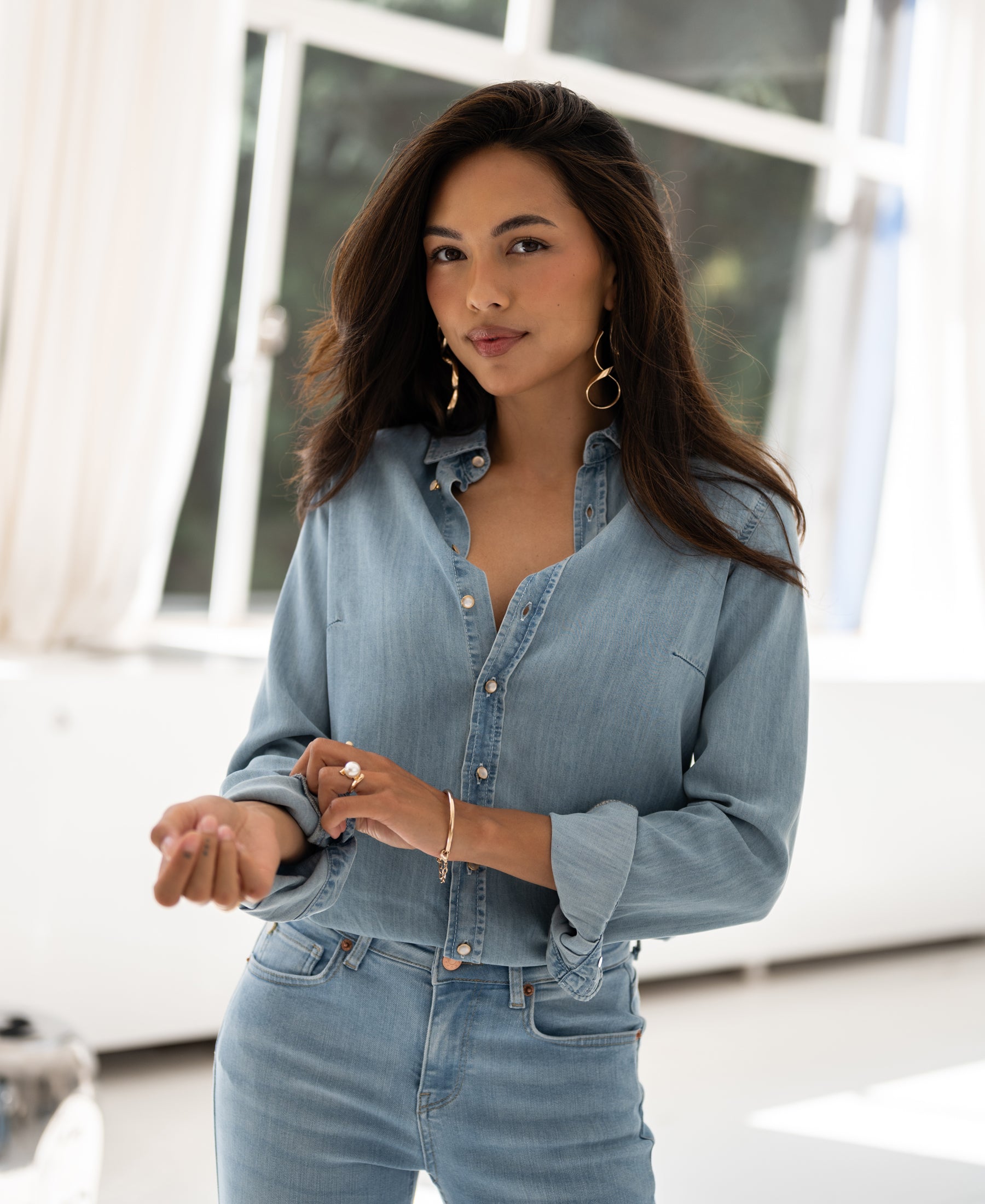 Bleached Tencel denim blouse in light wash, shown on model indoors. Product is sold out.
