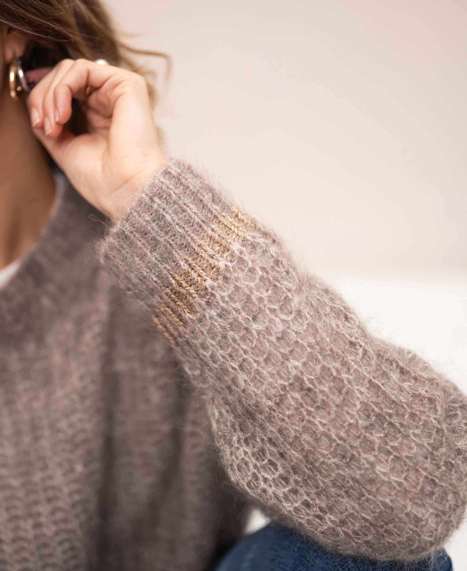 Close-up of a beige mohair sweater from PLEIN PUBLIQUE, seen in detail.