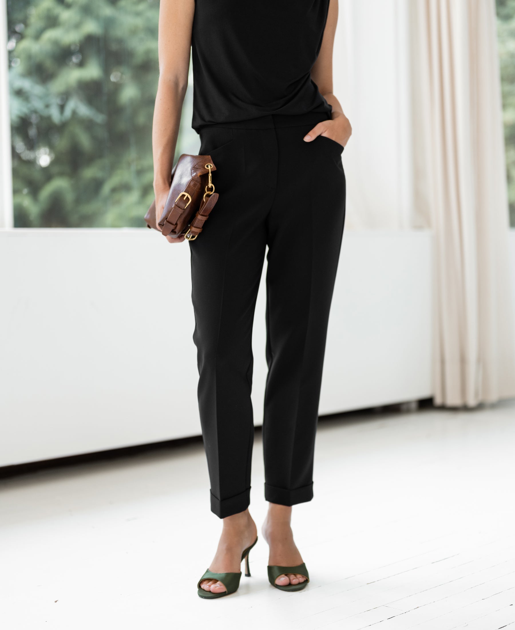 Black cropped pants with a 7/8 length displayed indoors.