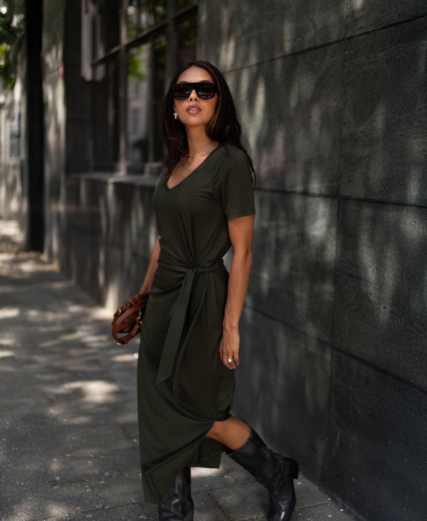 Dark olive green long dress in lightweight fabric from PLEIN PUBLIQUE, shown worn by a woman.