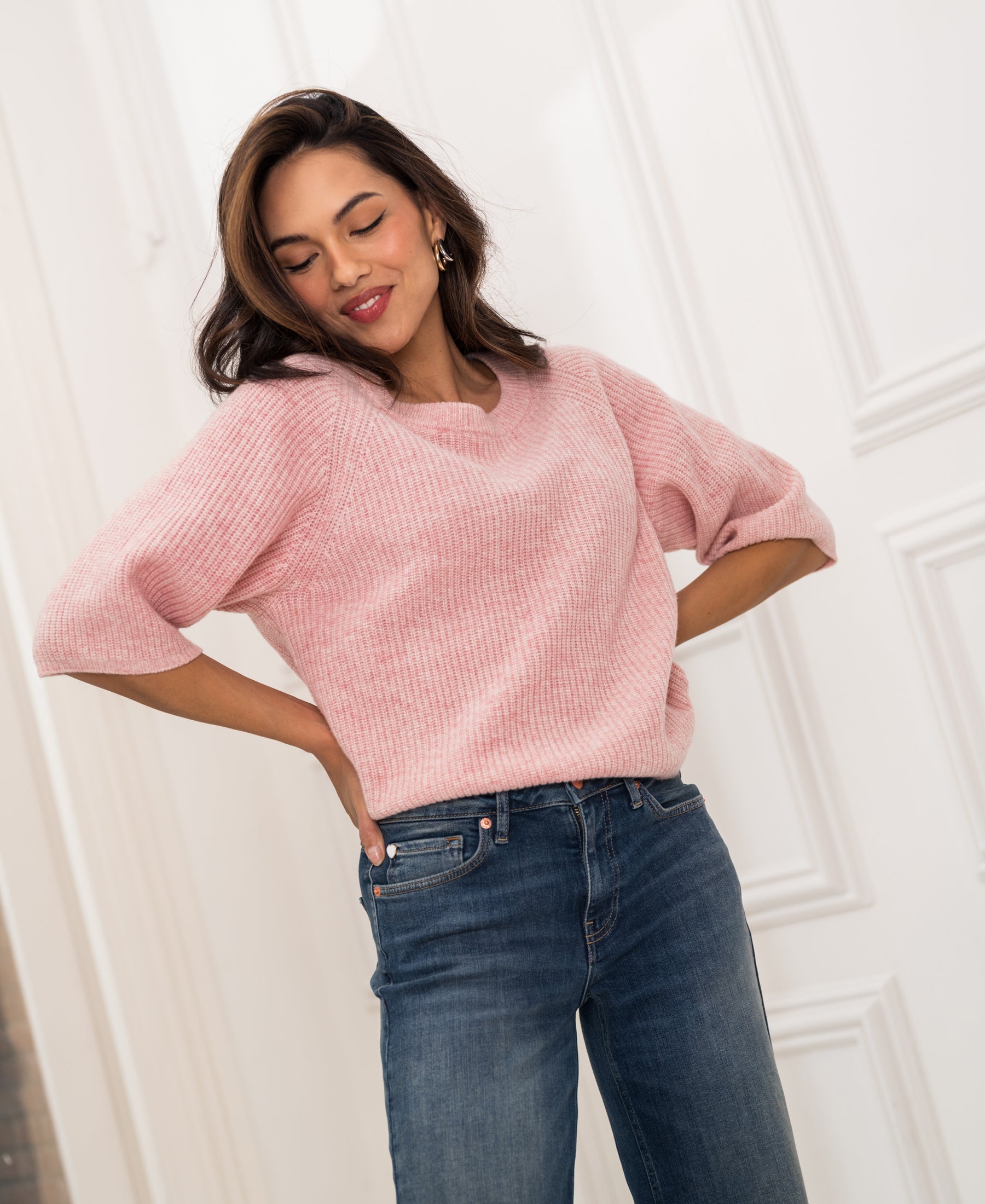 Pink knit sweater (the LA FRAMBOISE by PLEIN PUBLIQUE) shown on person in a bright room.