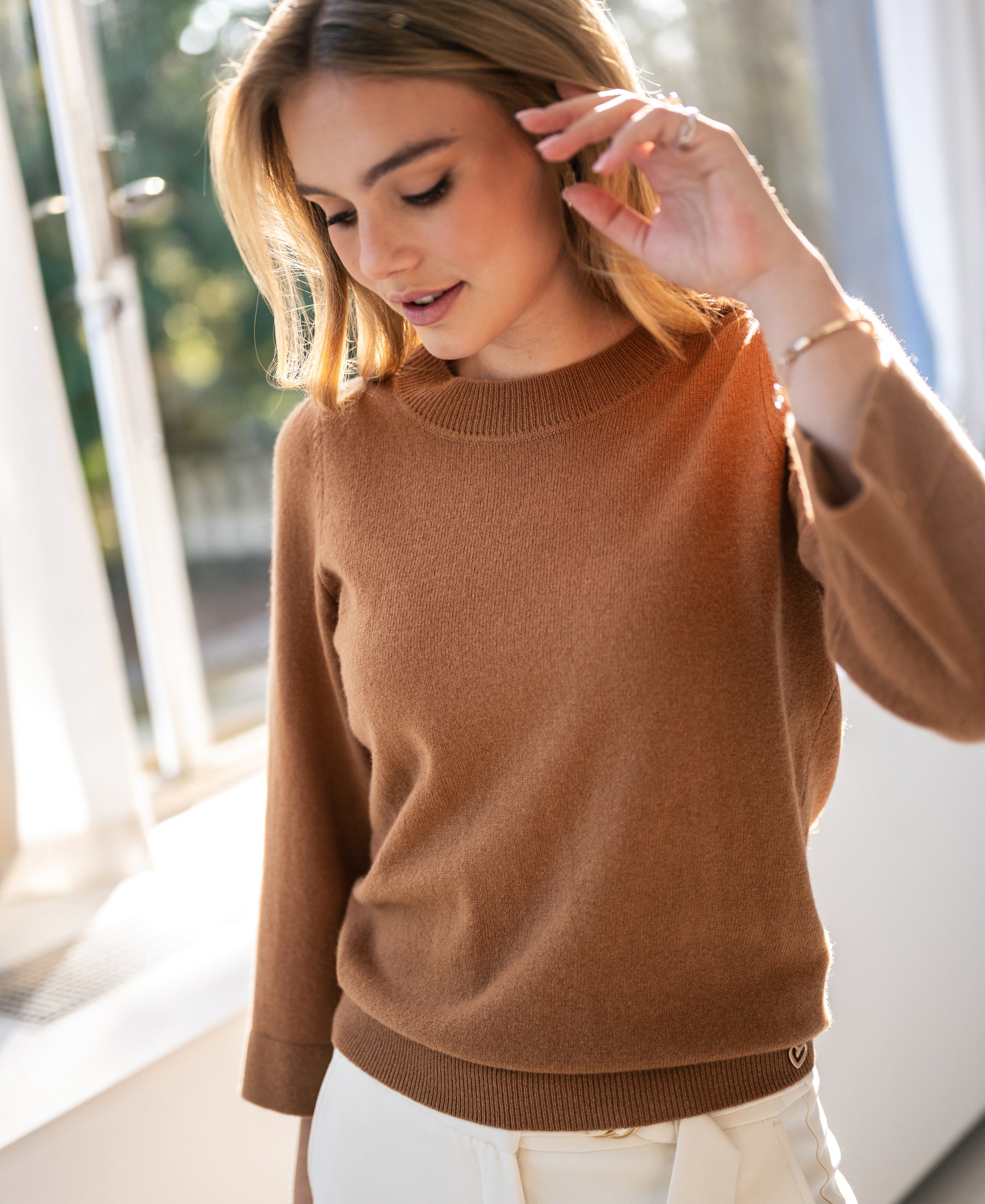 Camel-colored merino wool sweater shown in natural light.