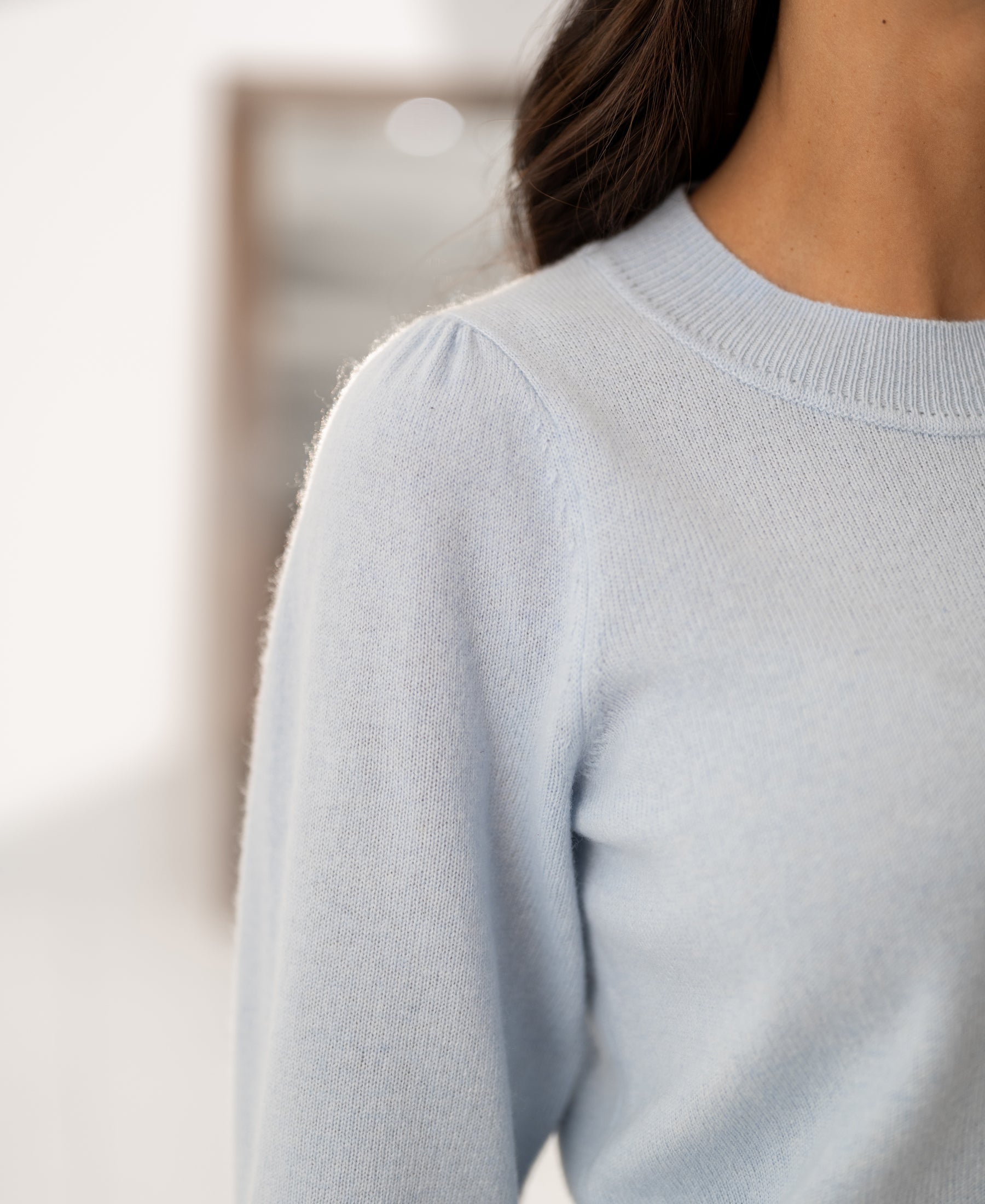 Close-up of light blue Merino wool sweater LE FREJUS by PLEIN PUBLIQUE, knitted with kimono sleeves at shoulder and neck.