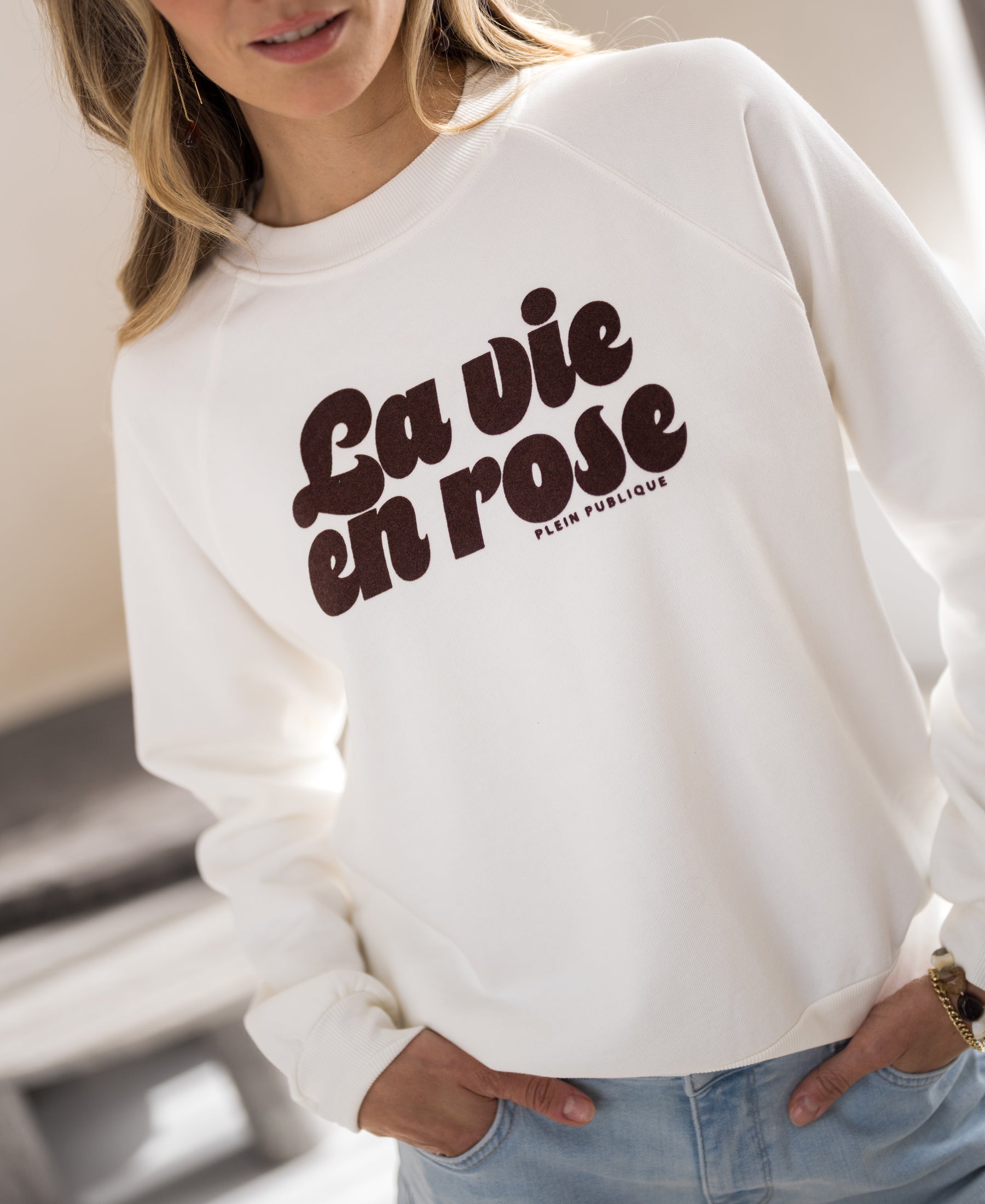 Ivory and cocoa LA HARPER sweater by PLEIN PUBLIQUE, shown indoors.