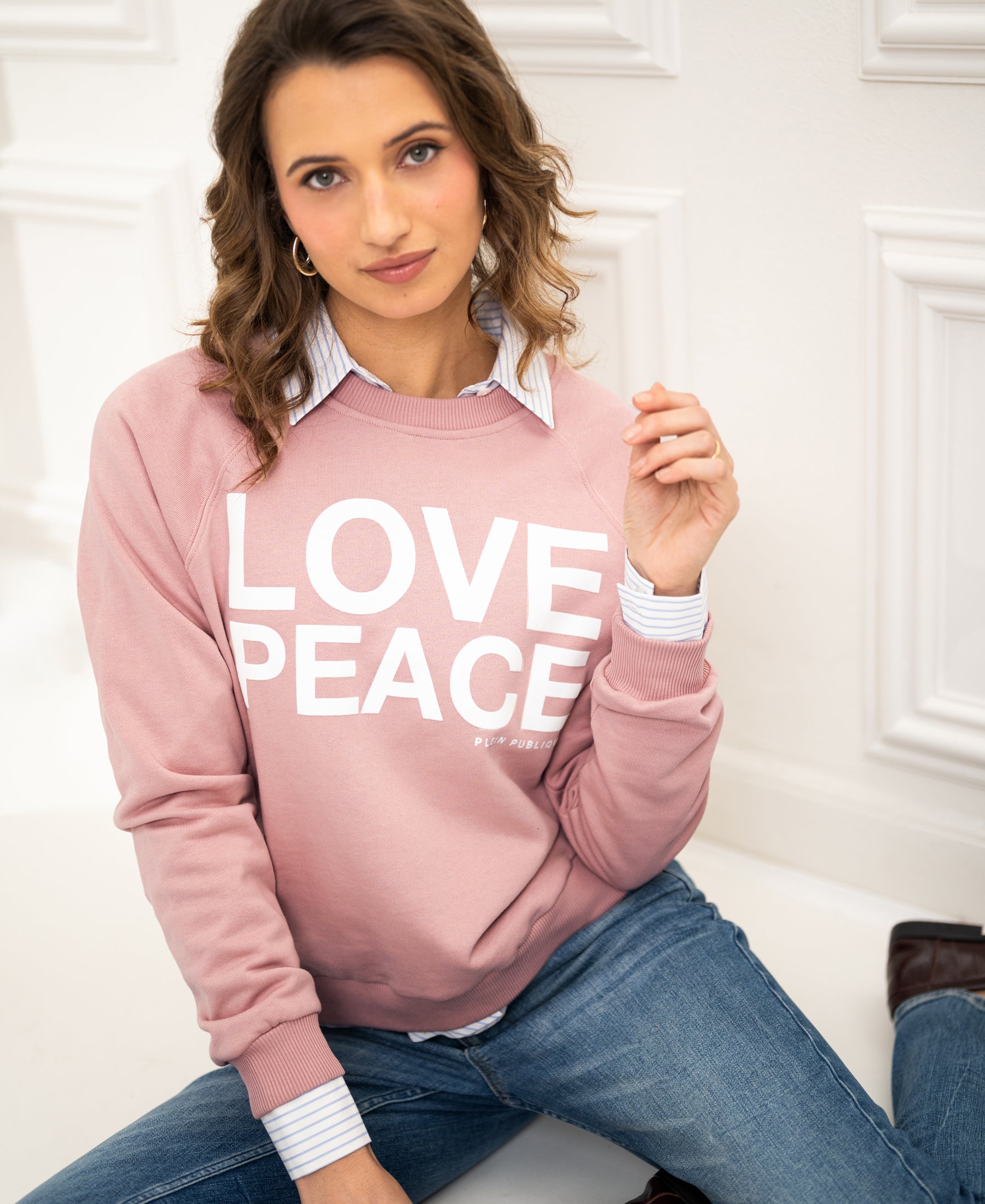 Antique rose LOVE PEACE sweater in soft knit with text detail, front view.