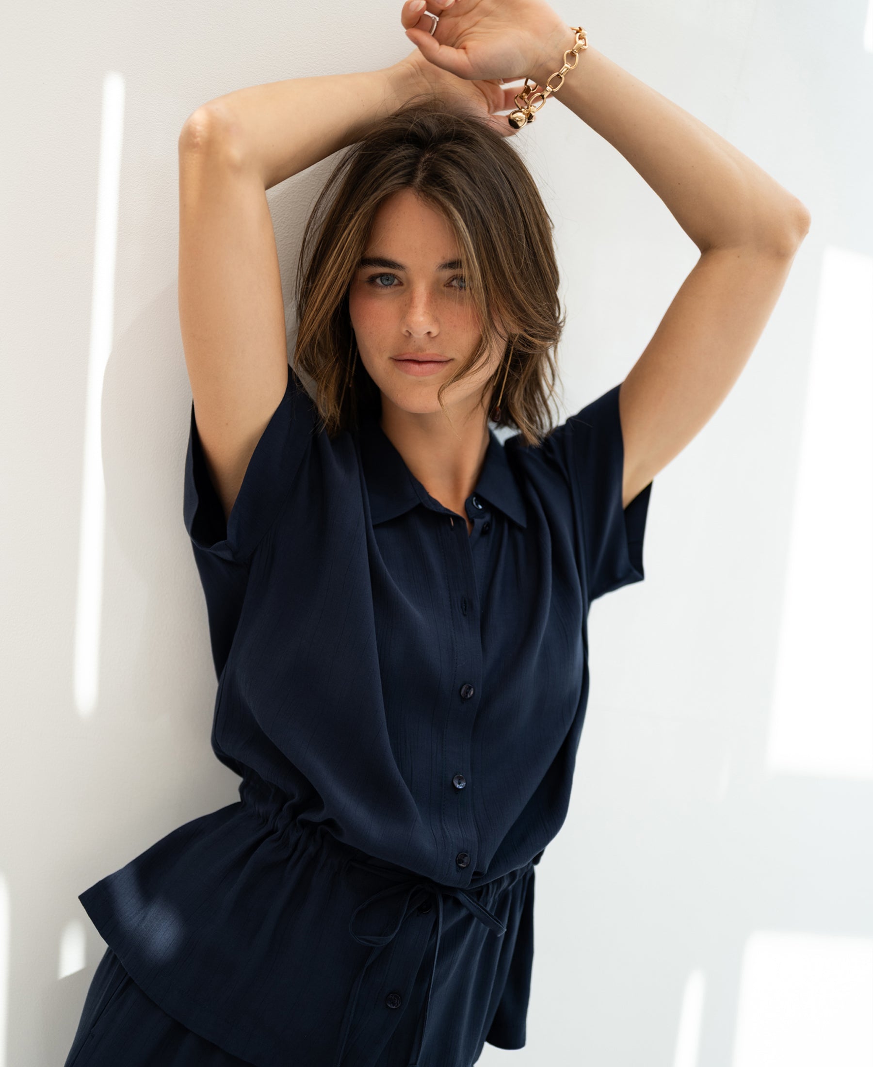Navy blue viscose blouse, LA JODY by PLEIN PUBLIQUE, shown with one sleeve raised.