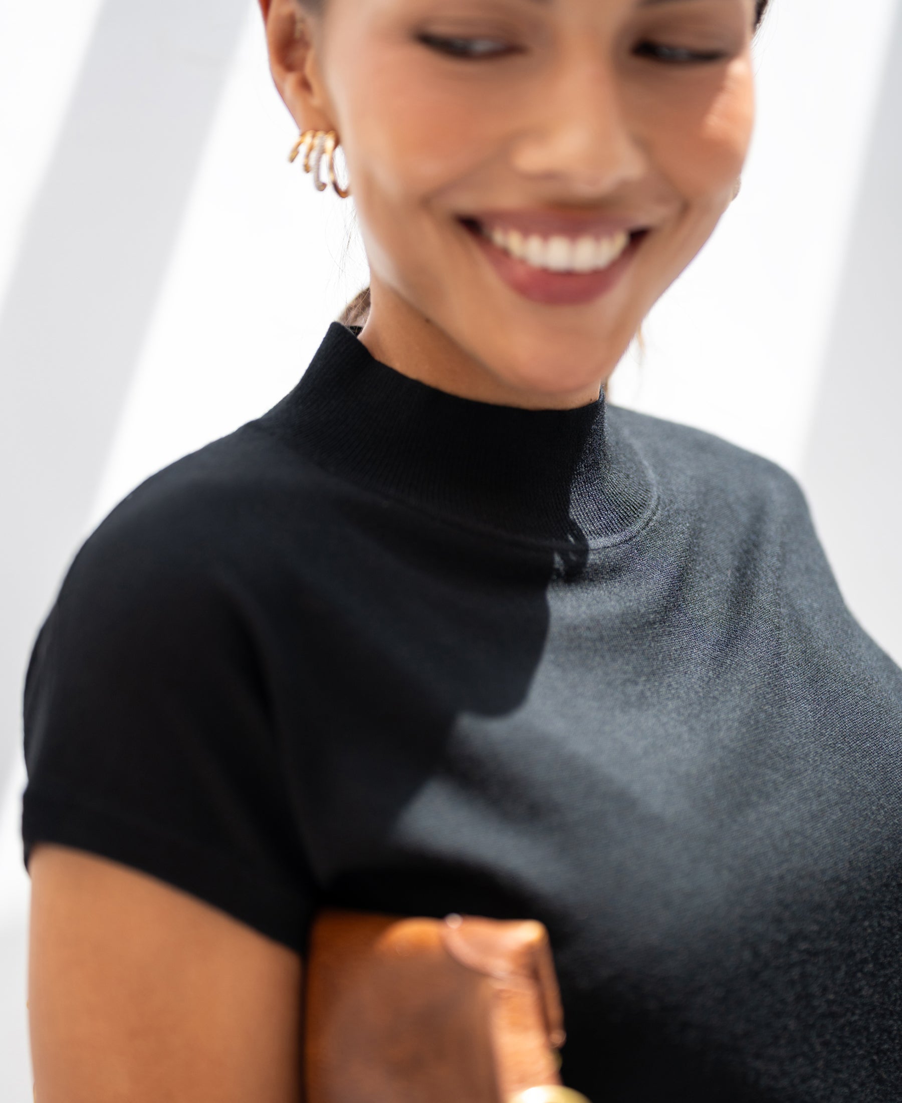 Woman wearing black Merino wool top.