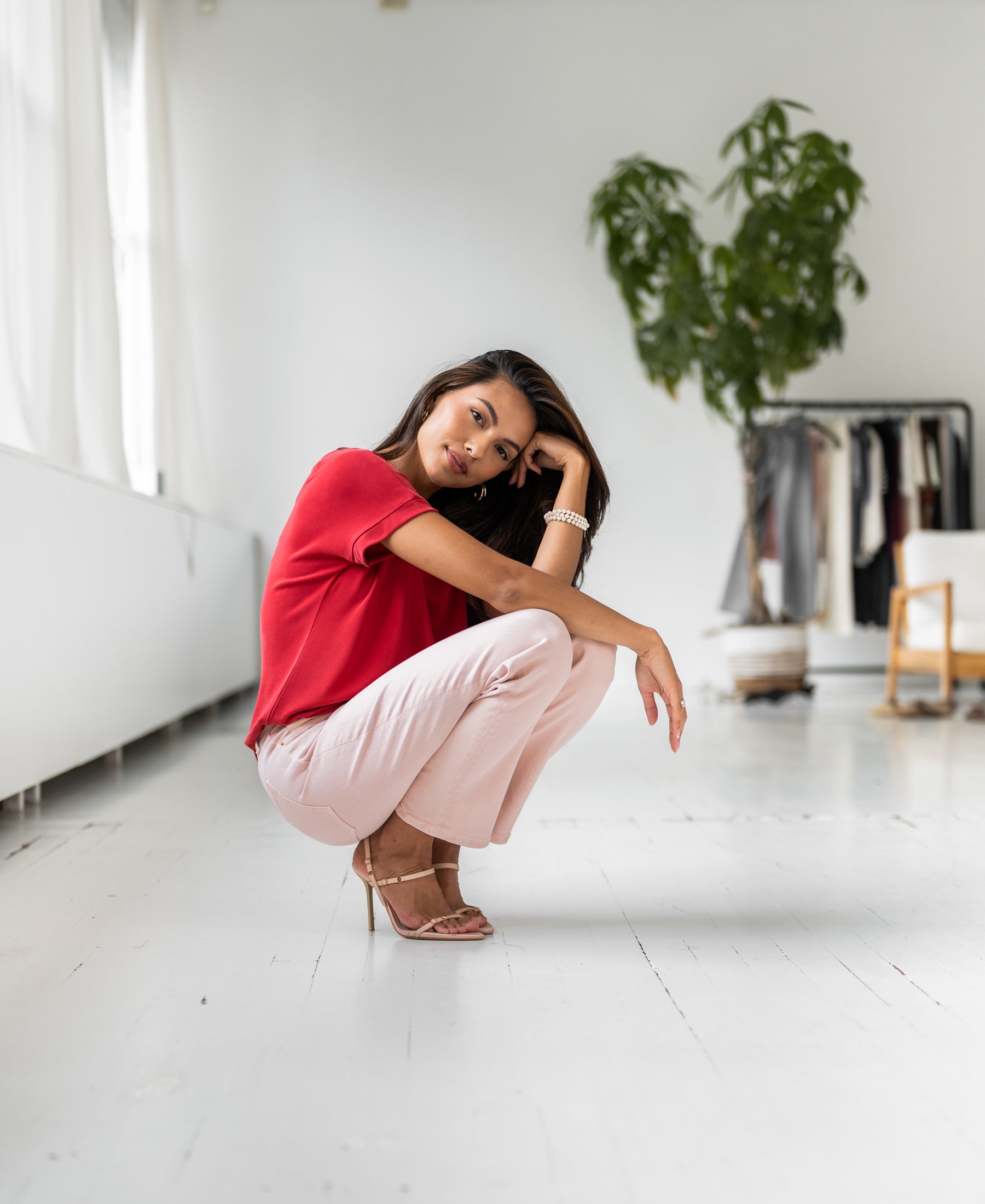 Red two-way T-shirt by PLEIN PUBLIQUE, shown on a woman in a bright room.