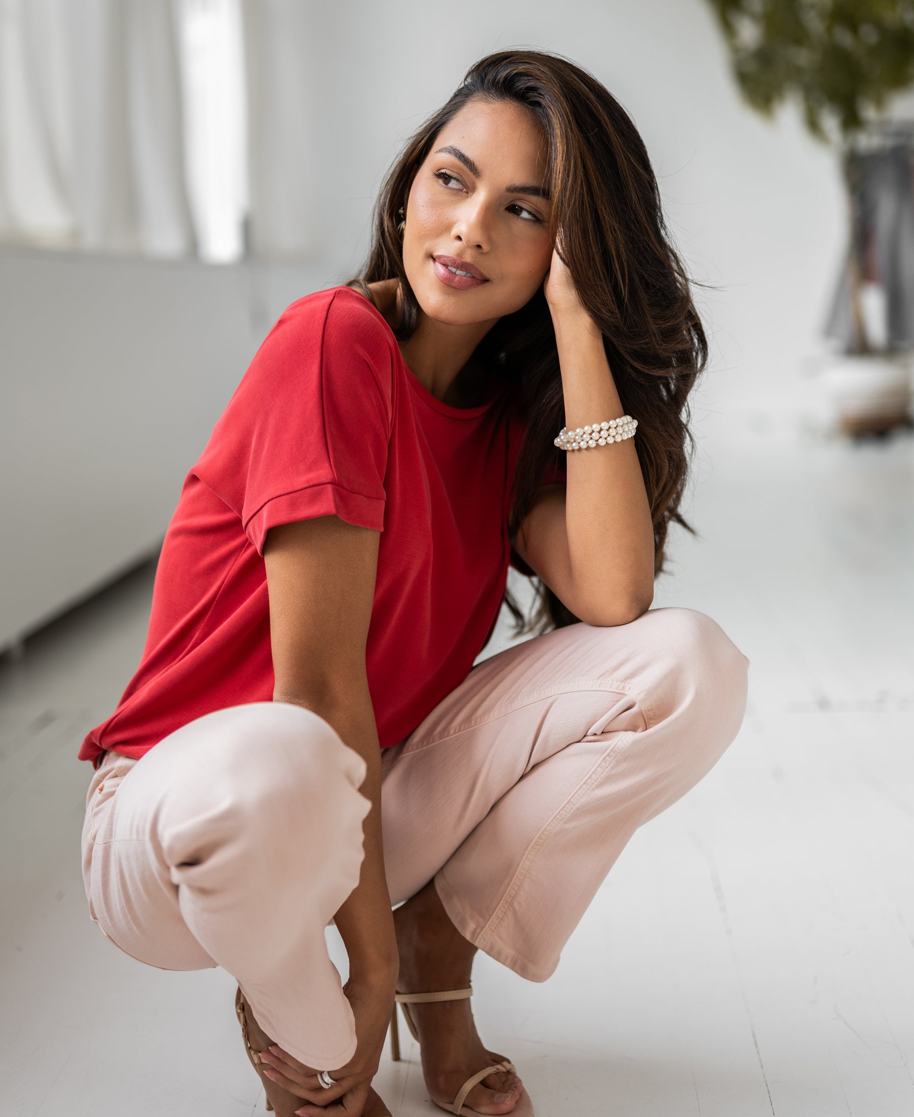 Red two-way T-shirt shown indoors; front view on model.
