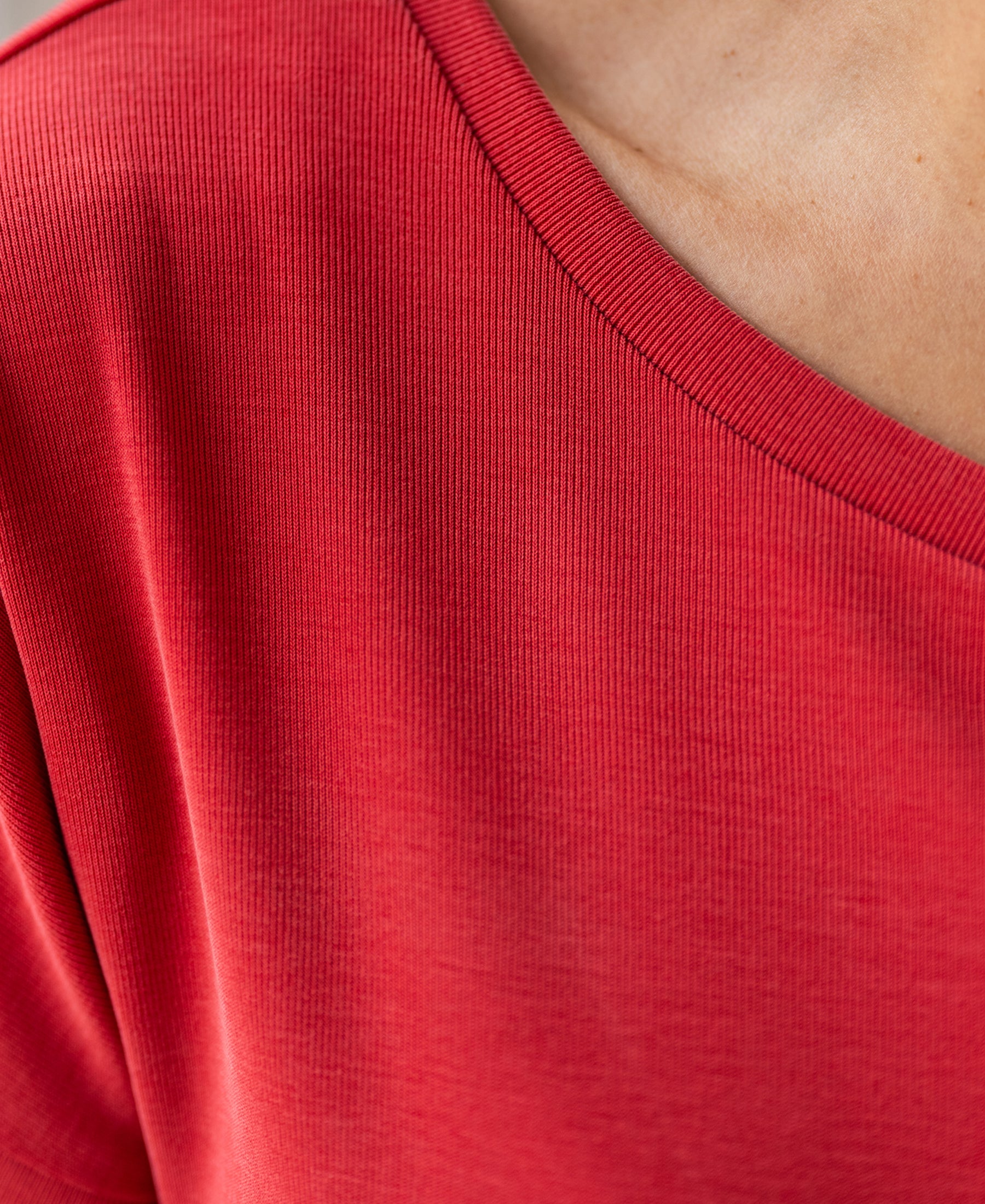 Close-up of a red PLEIN PUBLIQUE two-way T-shirt with a V-neckline.