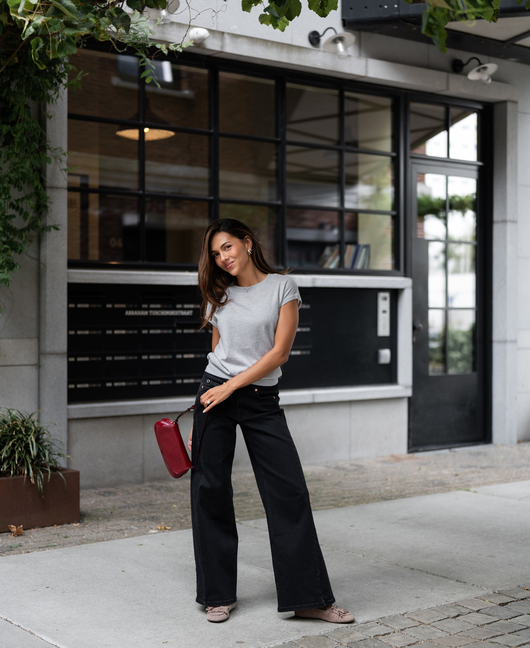 Woman wearing light gray Merino wool top.