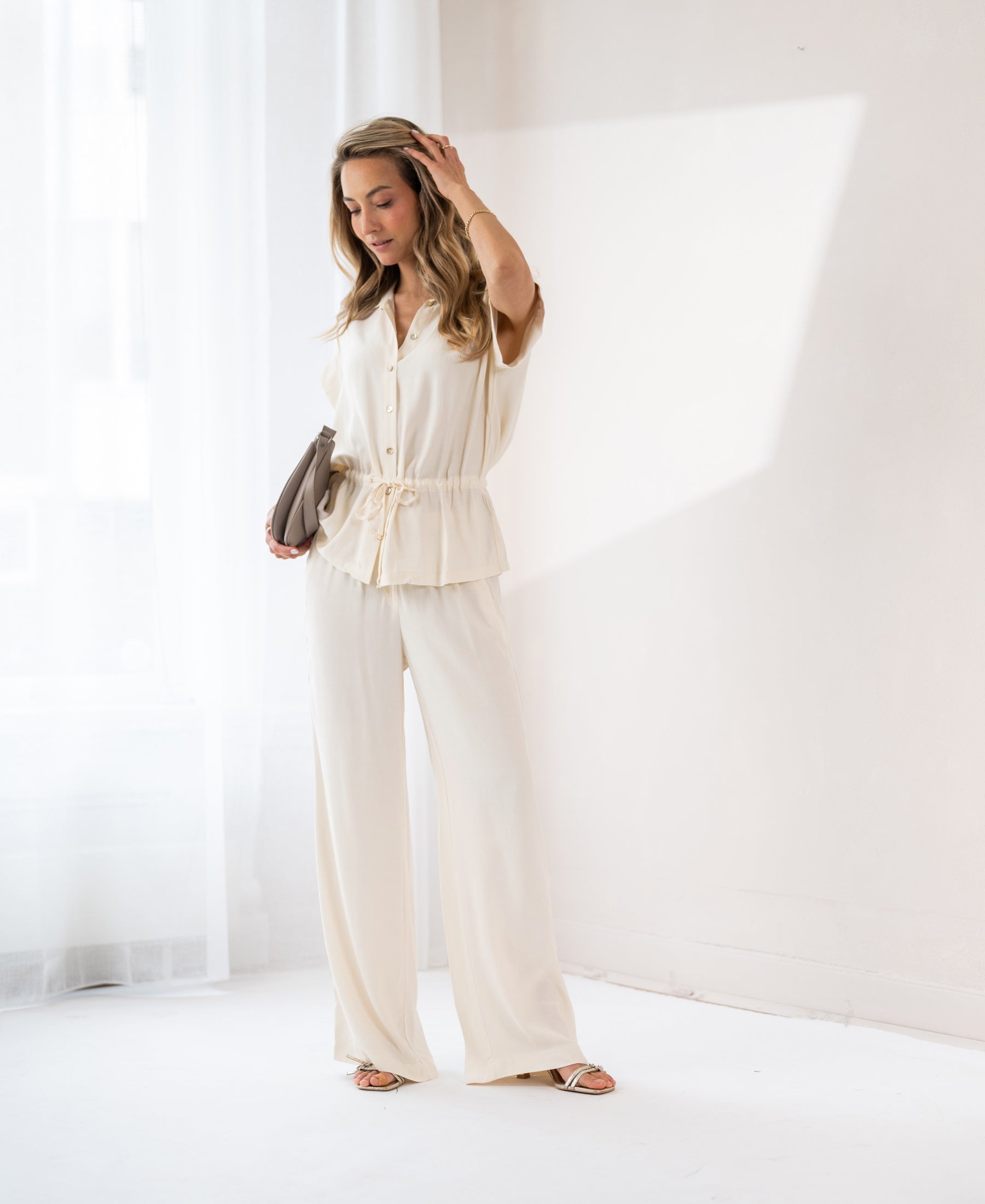 Cream-colored LA JODY blouse by PLEIN PUBLIQUE, shown on a model.