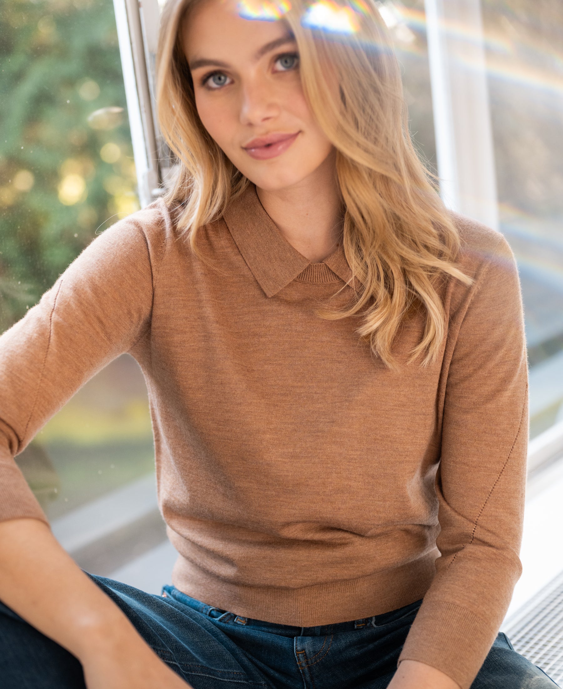 Merino wool sweater in chai tea color, shown by a sunlit window.