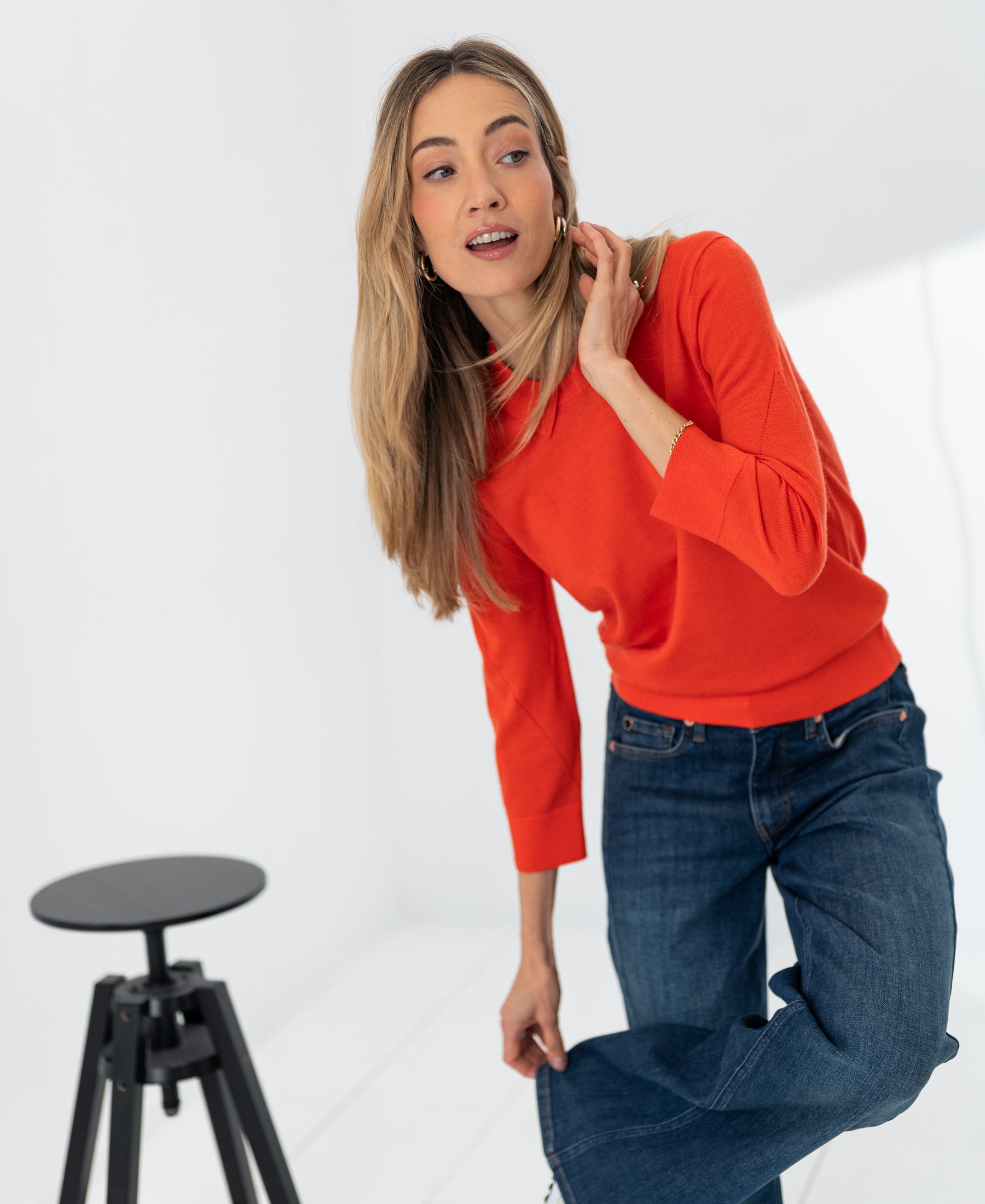 Coral red Merino wool polo sweater by PLEIN PUBLIQUE with collar, shown on model.