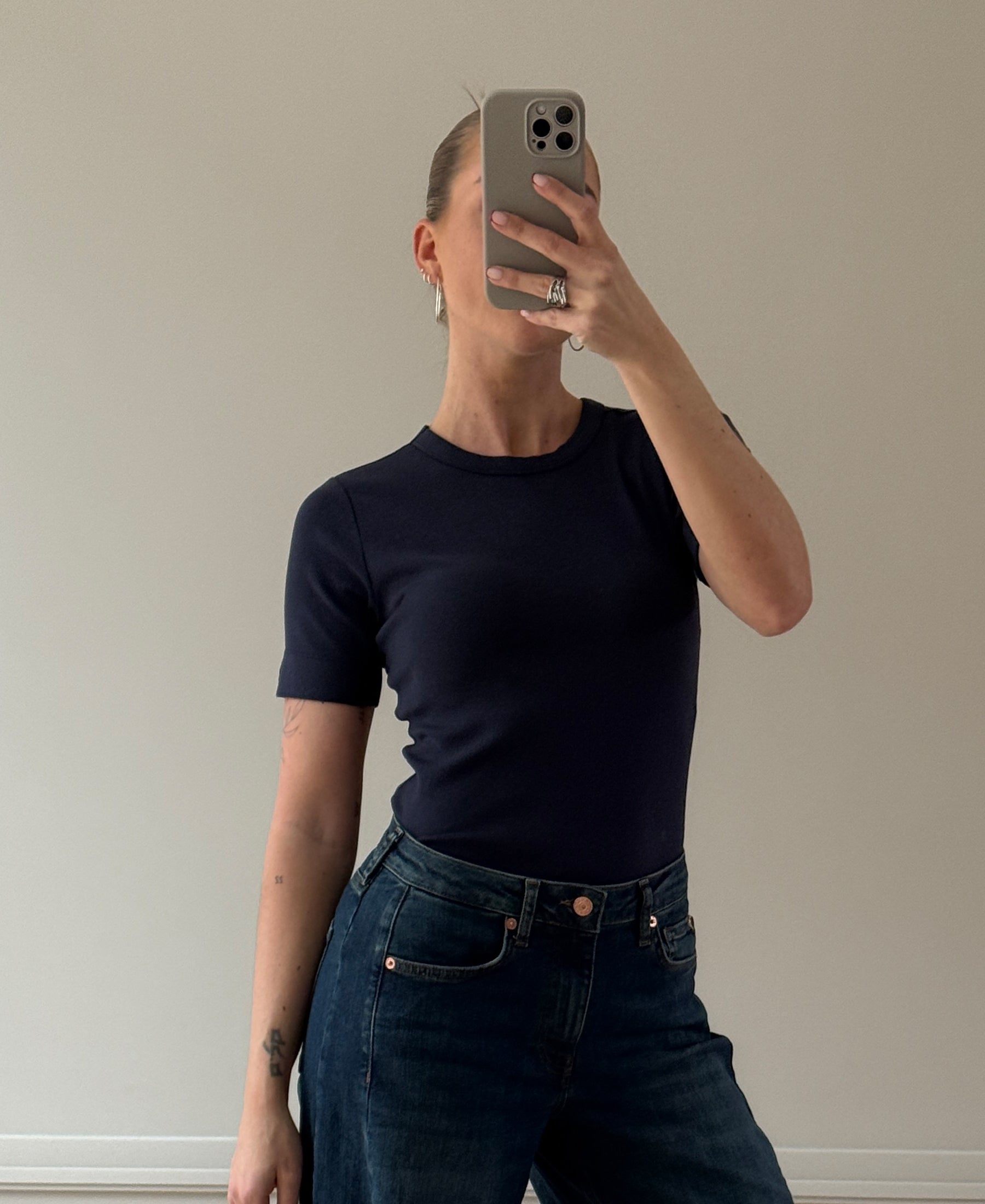 Navy blue Luxe & soft T-shirt by PLEIN PUBLIQUE, shown in a mirror selfie against a plain wall.