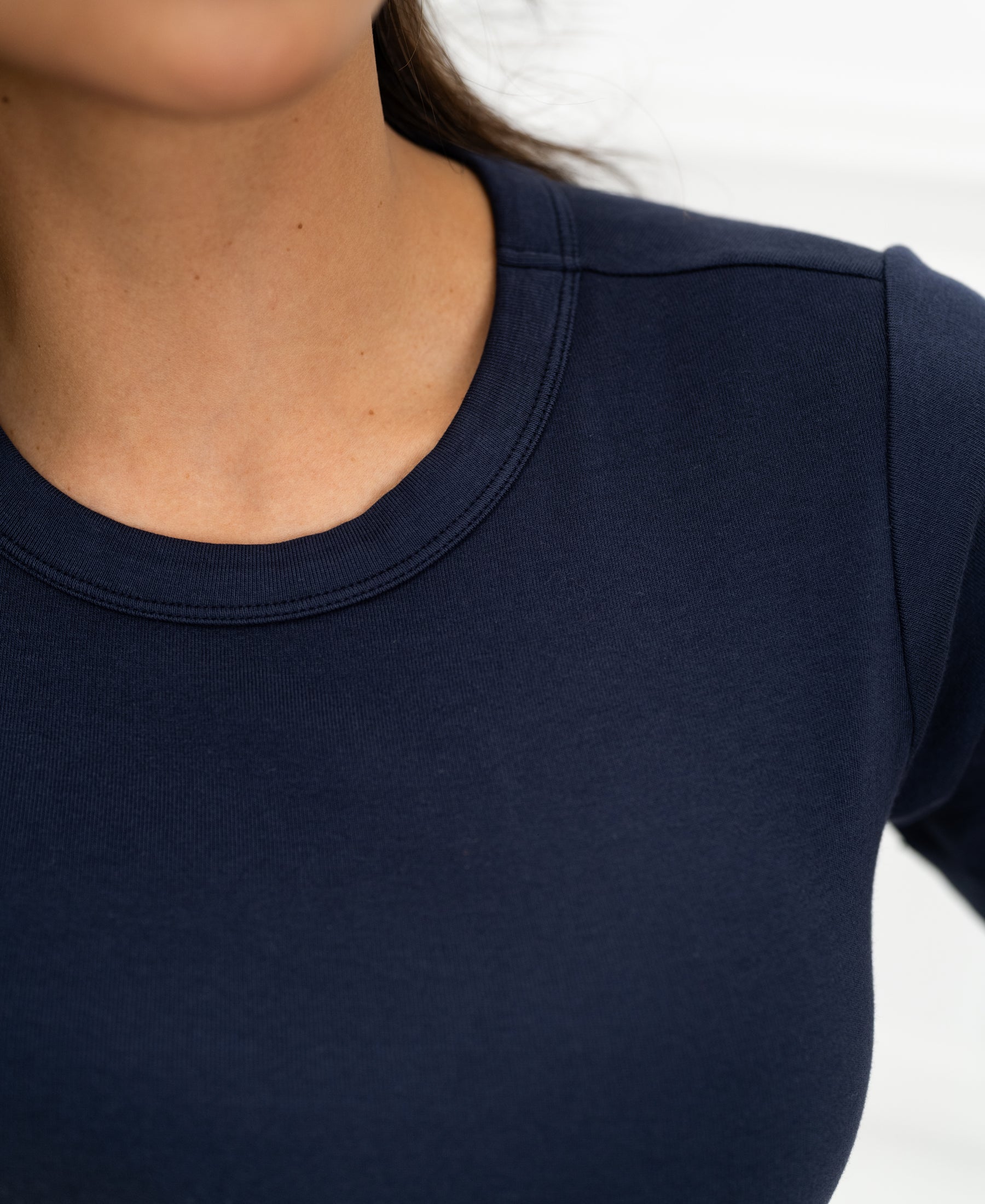 Close-up of the Luxe & soft dark blue T-shirt by PLEIN PUBLIQUE, showing fabric detail at the neck and shoulder.