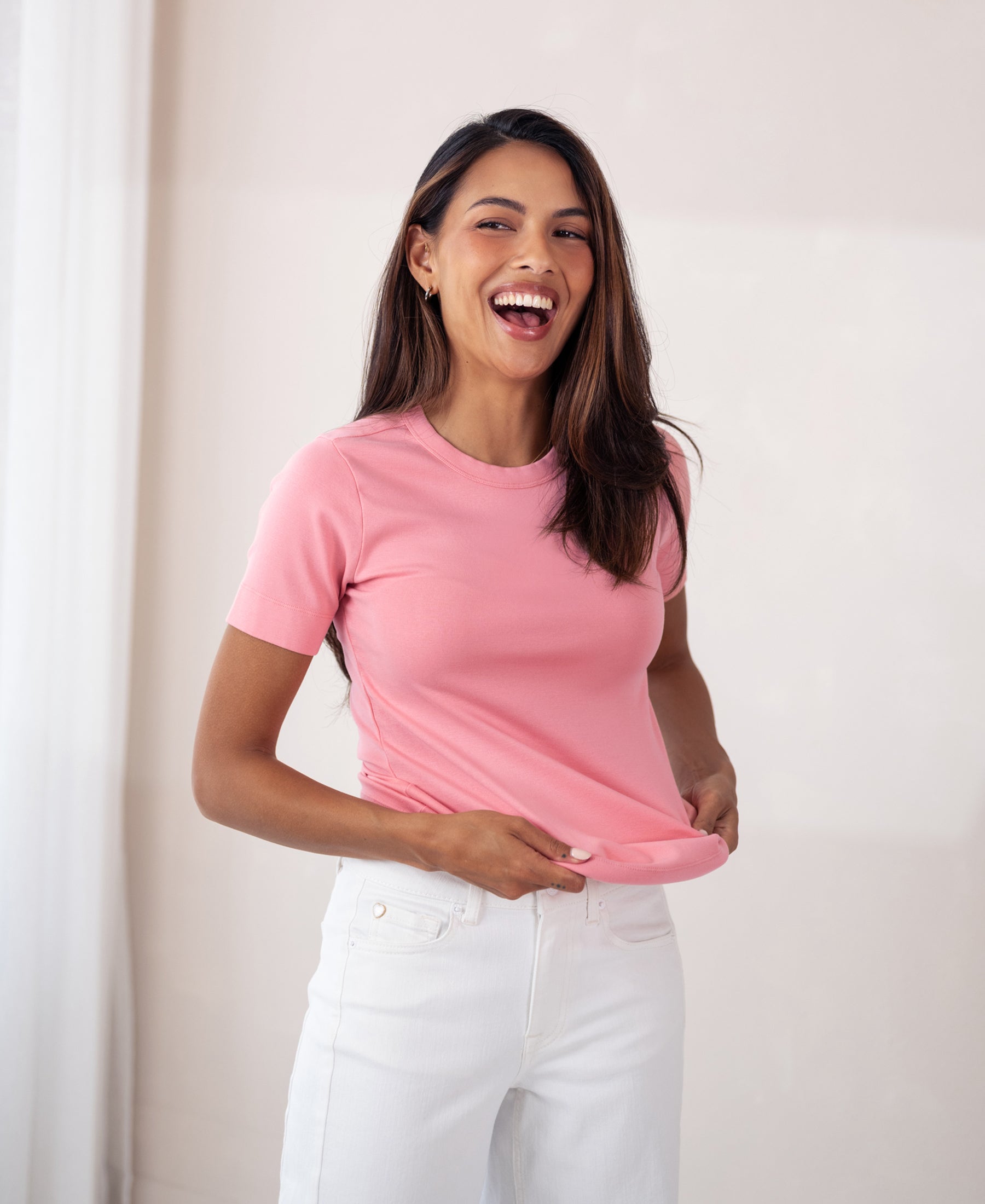 Soft pink LA MASSY T-shirt by PLEIN PUBLIQUE, shown indoors with a model holding the hem.