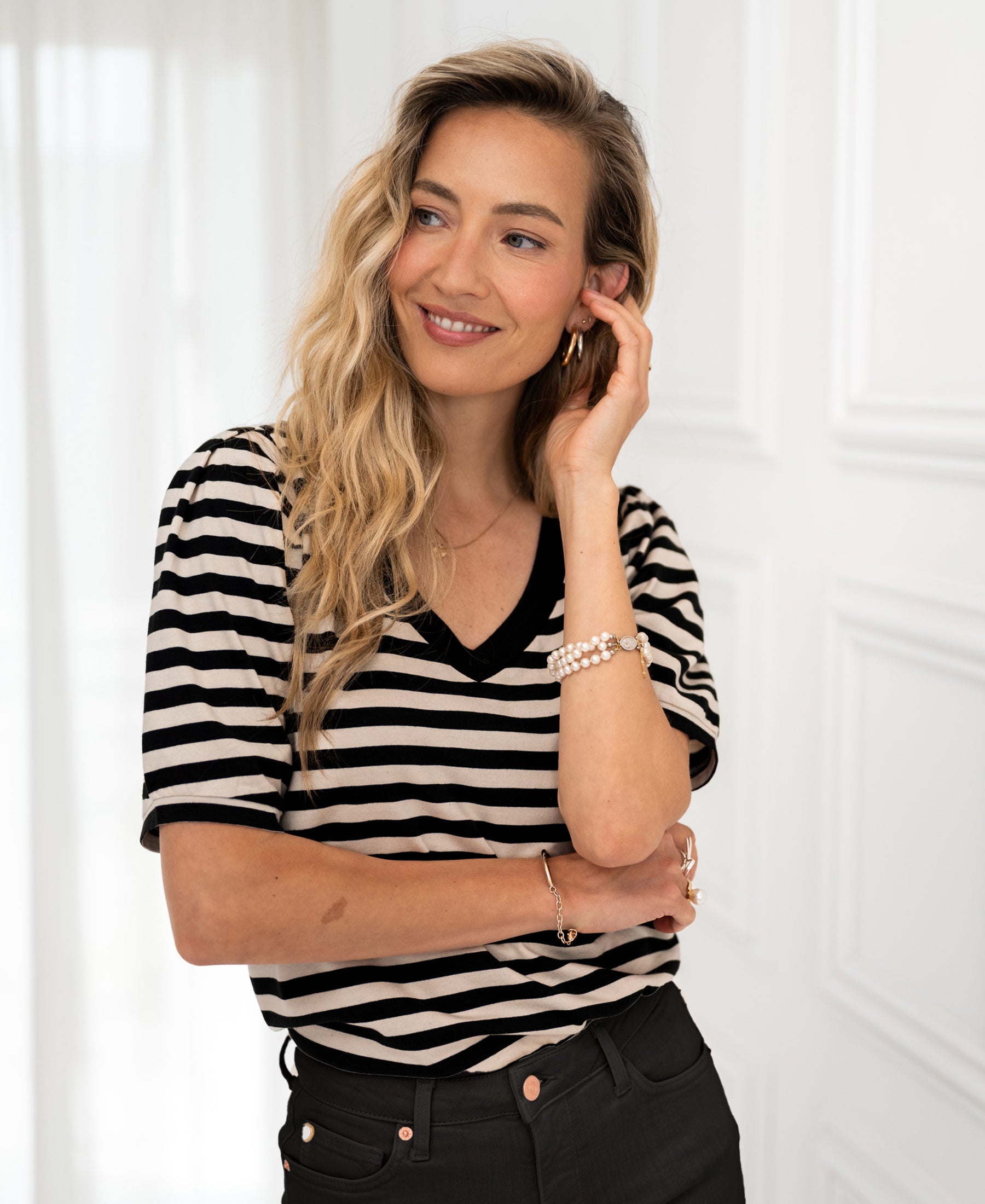 Black and beige striped V-neck shirt by PLEIN PUBLIQUE, front view.