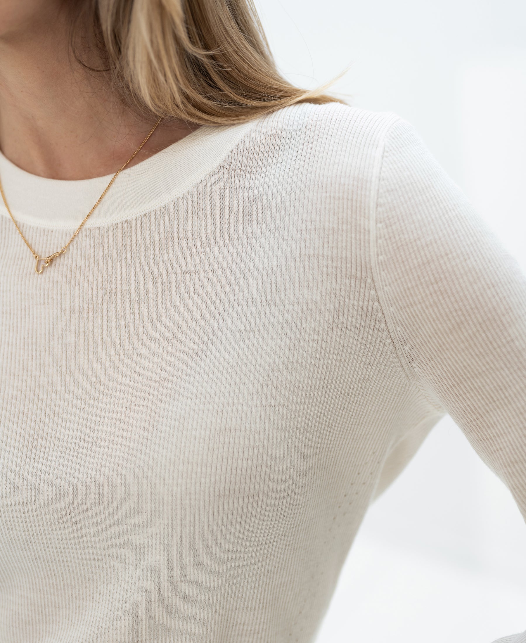 Ivory Luxe merino undershirt in a partial view from shoulders to mid-chest.