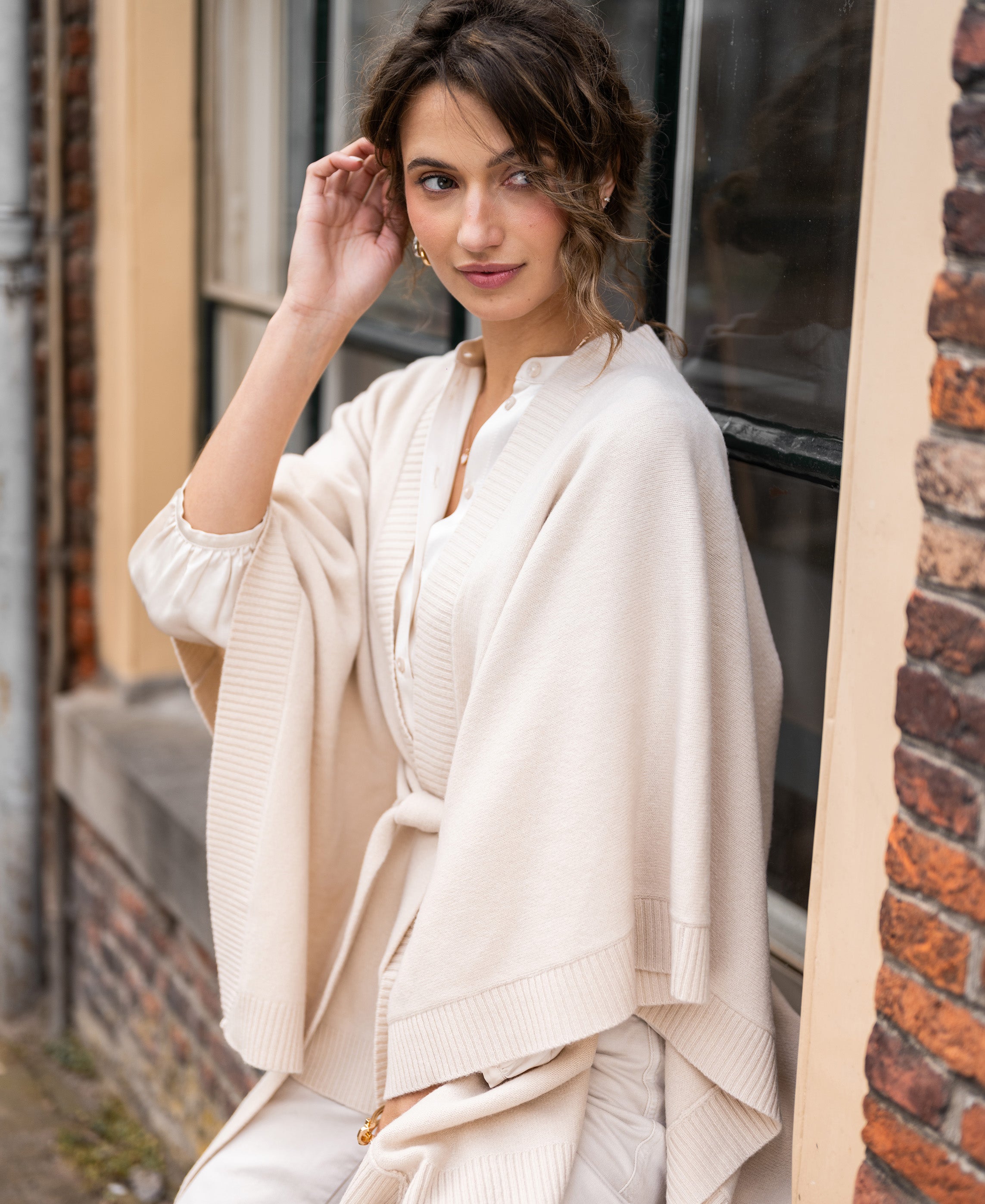 Light sand merino wool poncho by PLEIN PUBLIQUE.