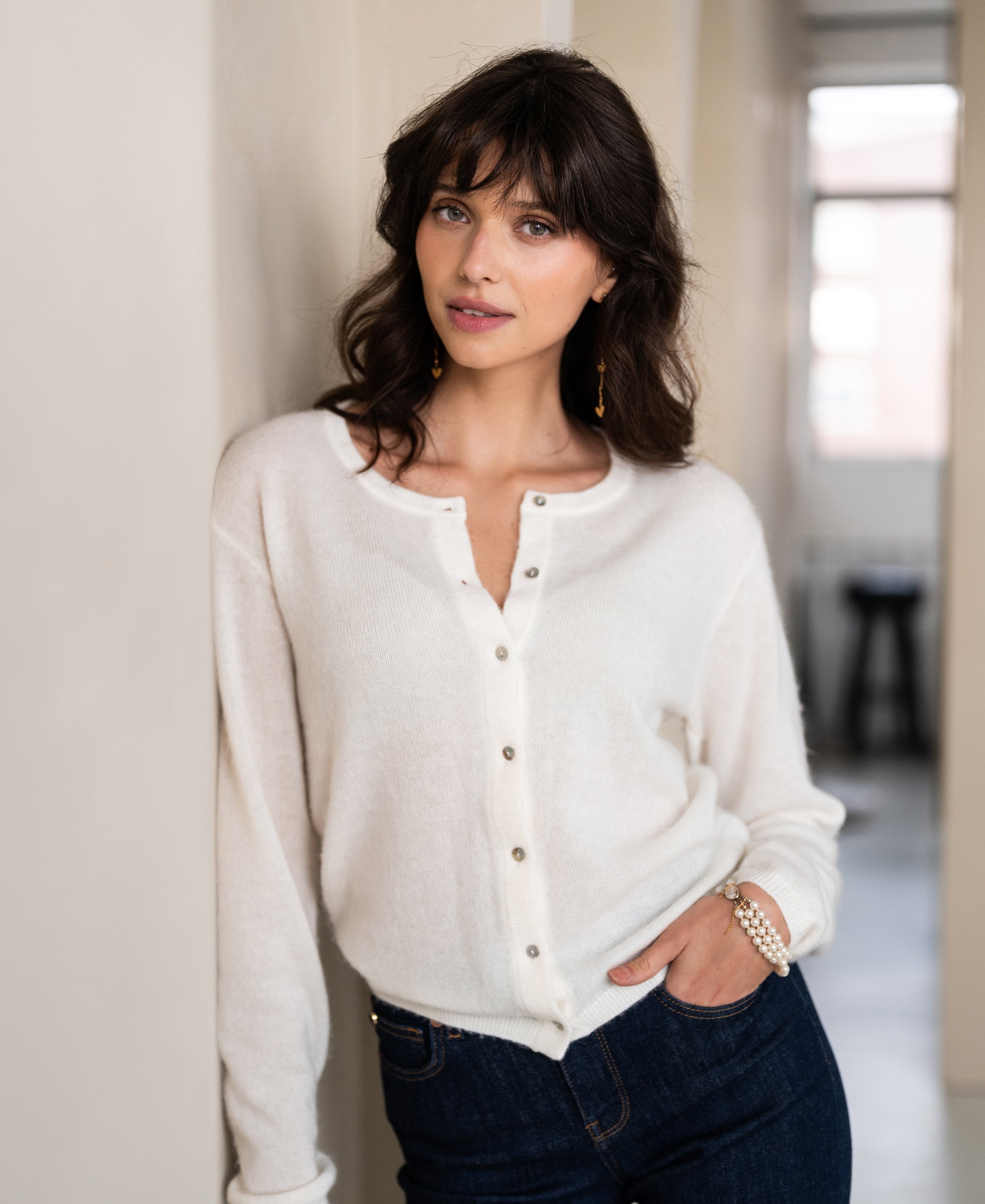 Ivory wool vest by SALE, shown indoors on a model.