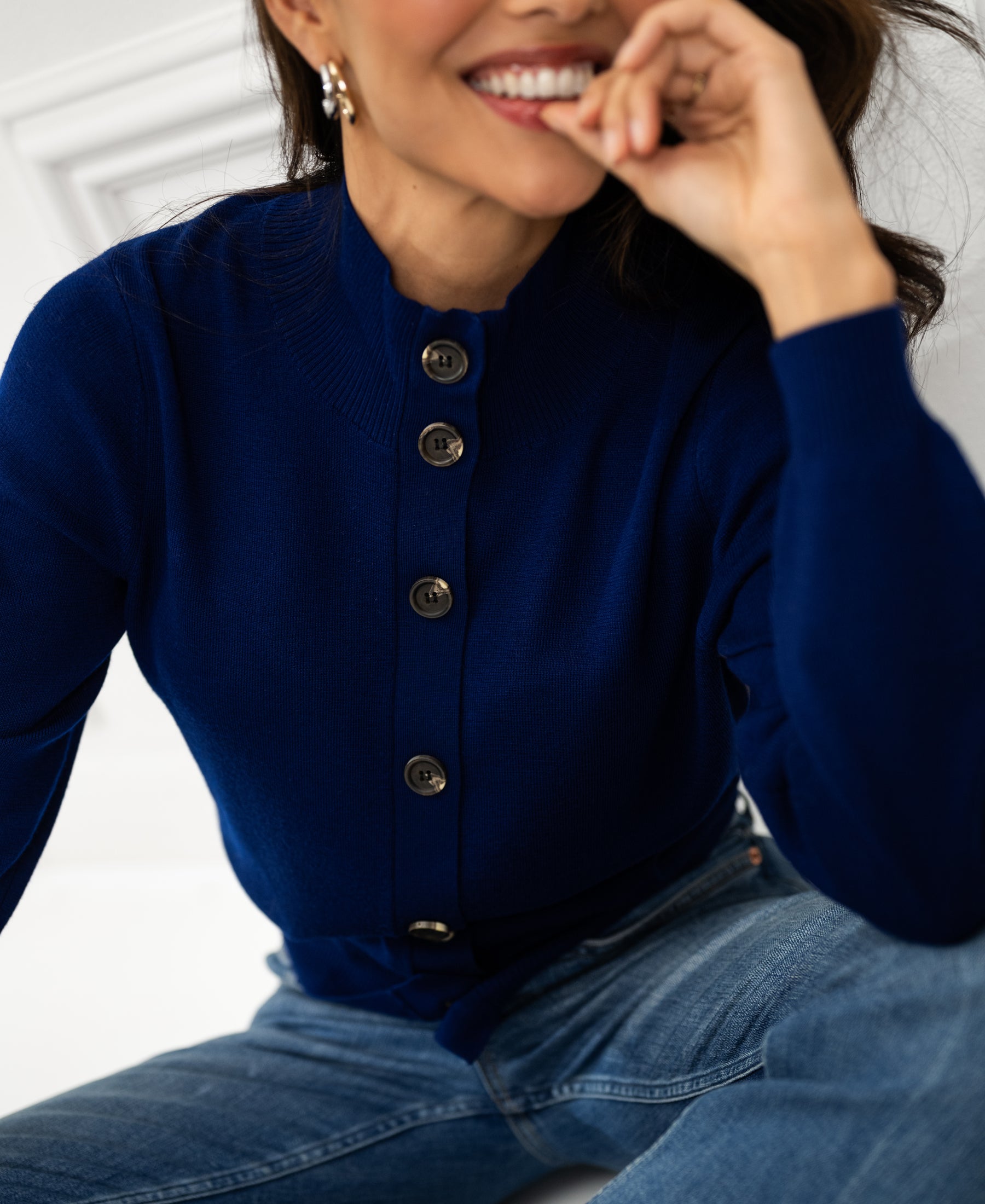 Woman wearing a PLEIN PUBLIQUE Merino wool turtleneck vest in navy blue.