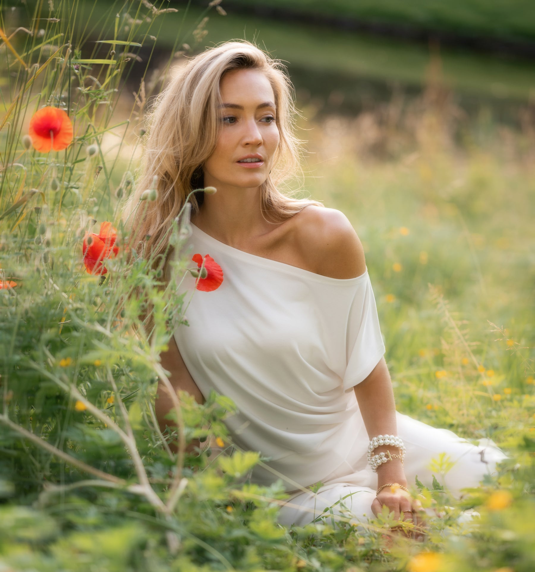 Ivory ribbed boatneck T-shirt by PLEIN PUBLIQUE, shown worn by a woman seated outdoors.