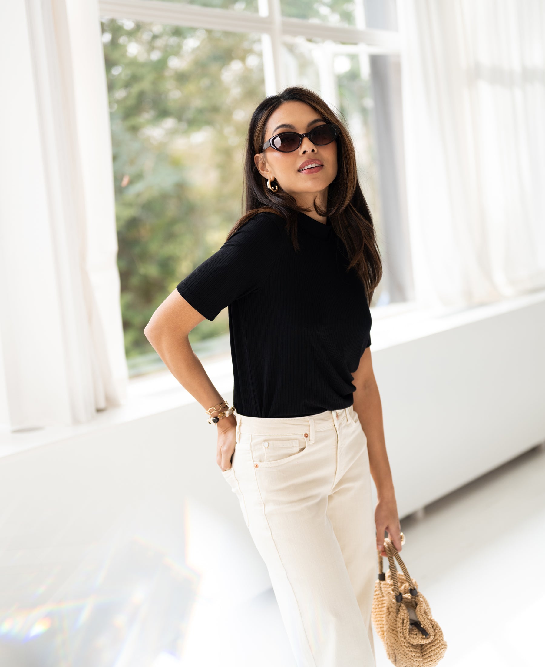 Woman wearing black bamboo turtleneck top.