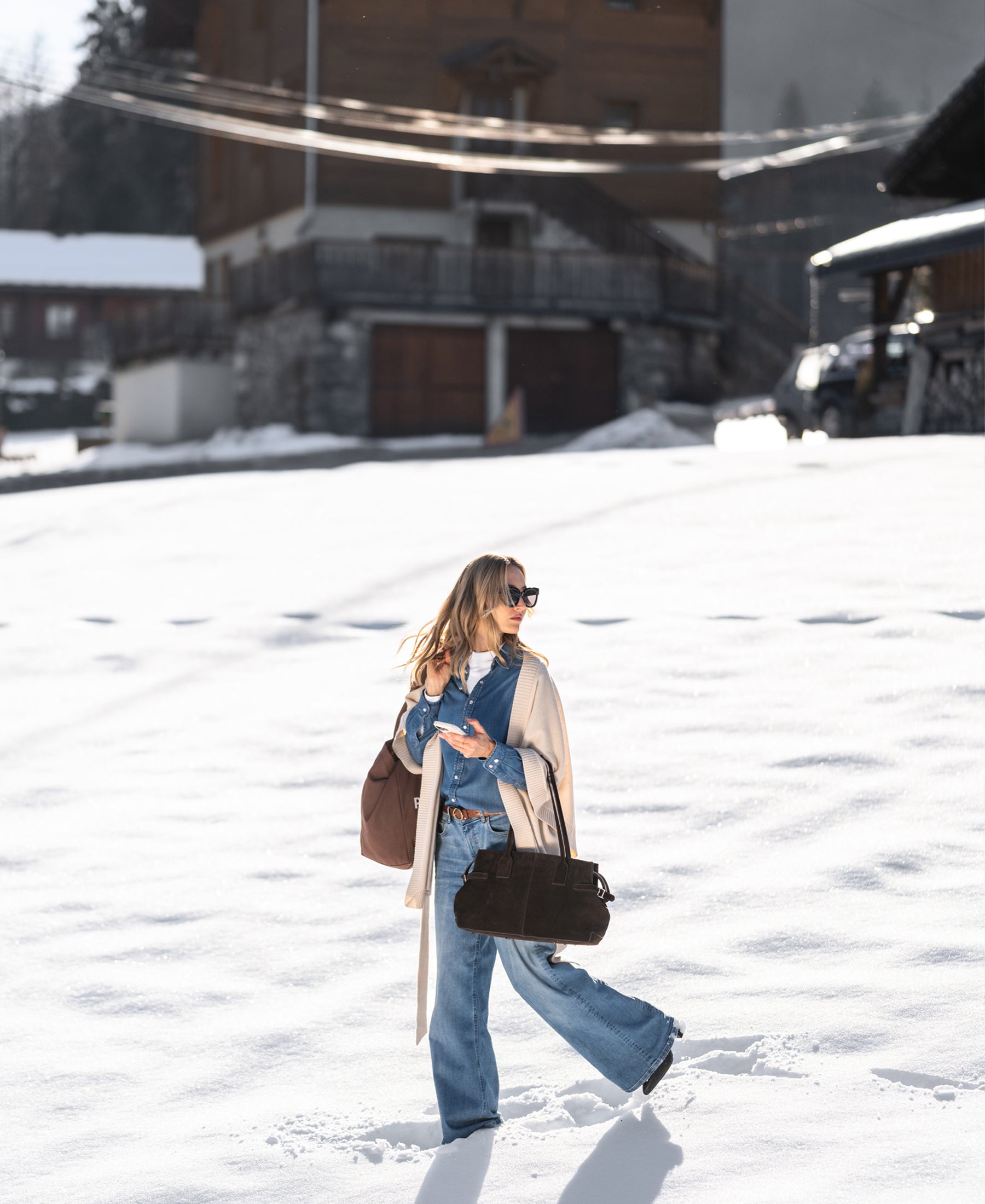 Blue stonewash Tencel denim blouse, front view, worn by a model outdoors in snowy setting.