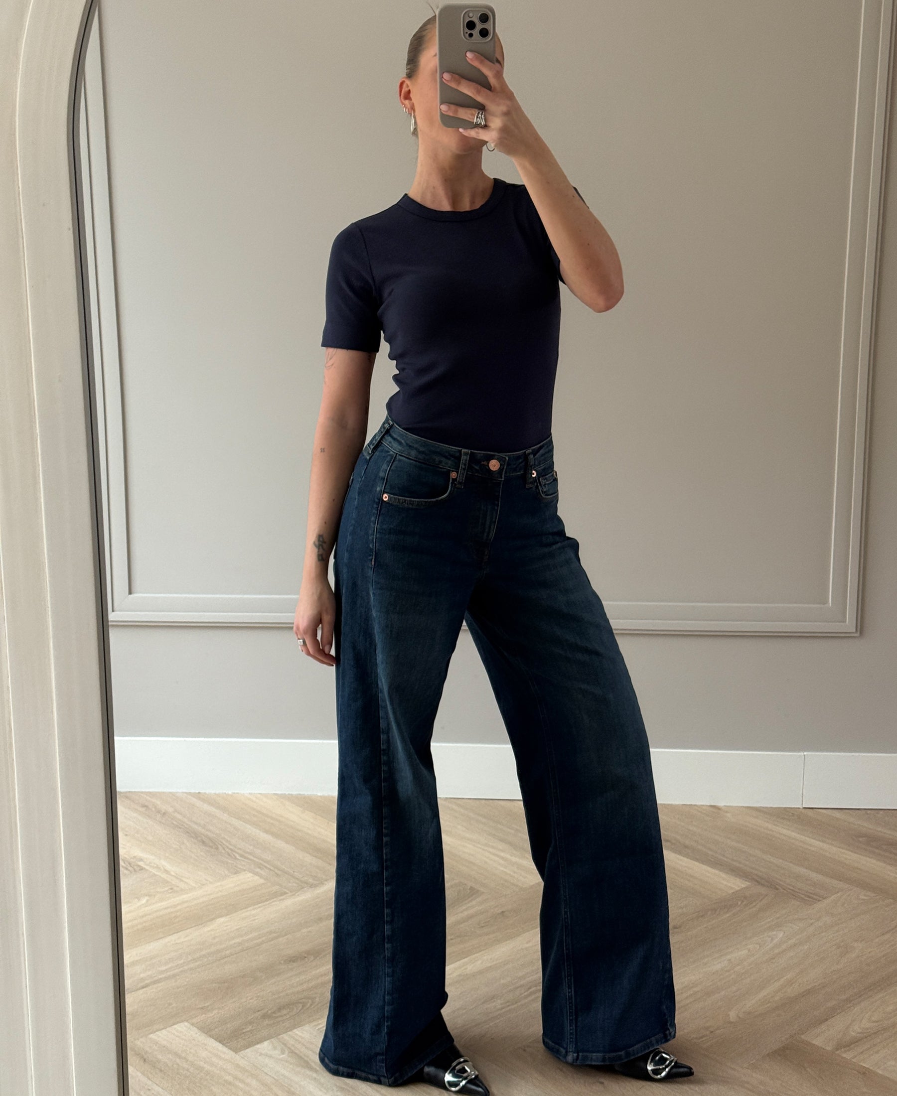 Wide leg blue heritage jeans in a mirror selfie, shown in a neutral room.