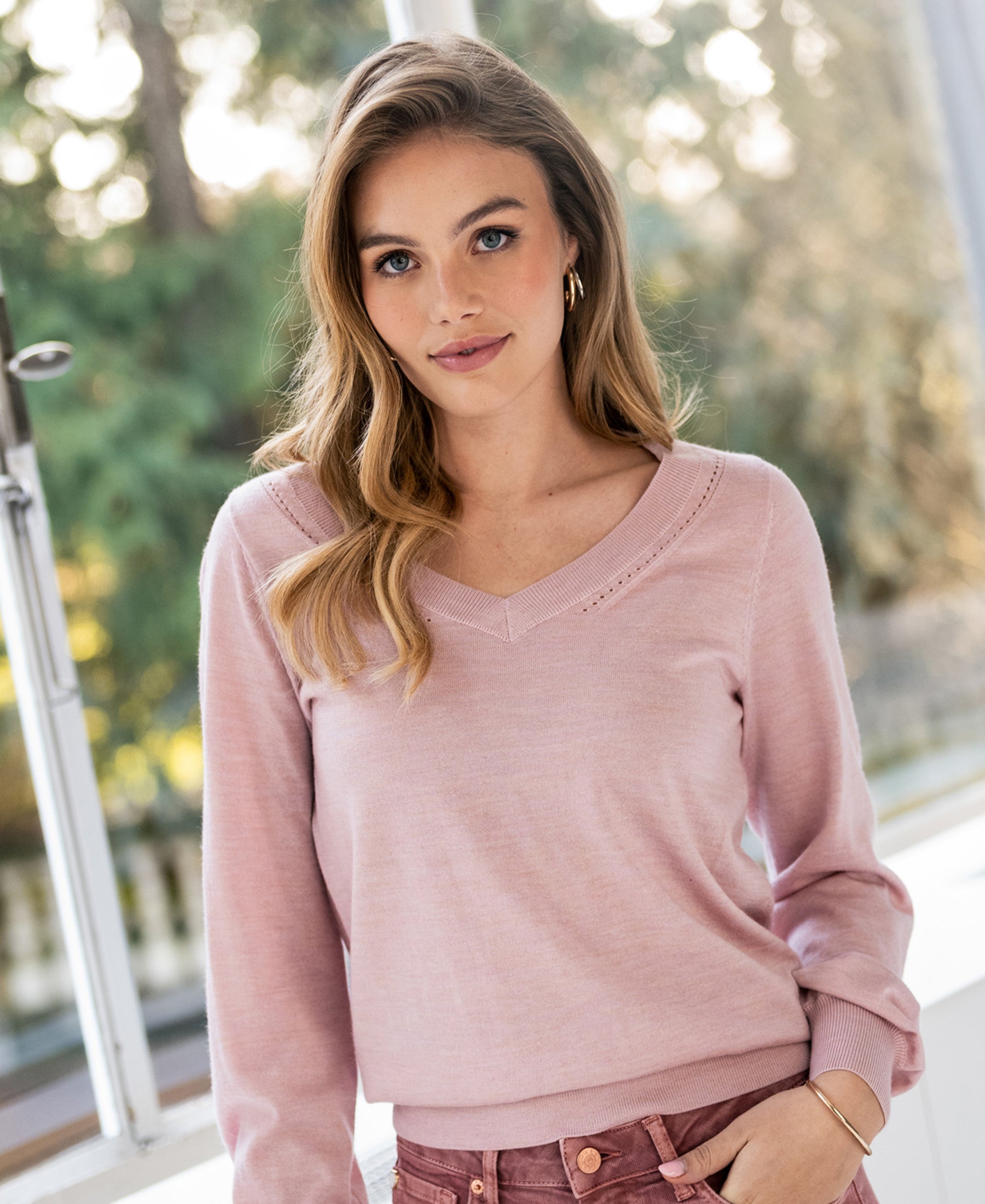 Pink PLEIN PUBLIQUE Merino wool V-neck sweater shown in sunlight.