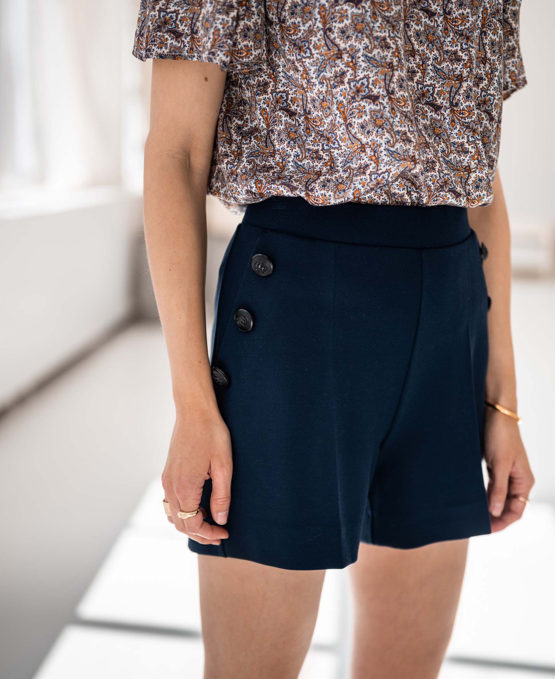 Women's LA PHILLY dark blue - black buttoned shorts by PLEIN PUBLIQUE, indoors.