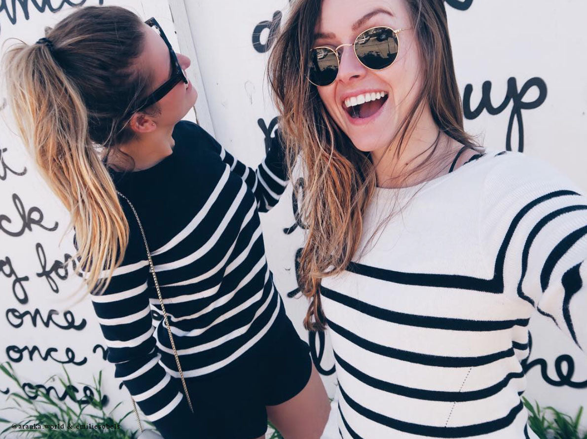 Woman wearing ivory-black PLEIN PUBLIQUE Breton stripe sweater L'ELISA, front view.