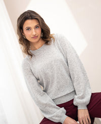 Light grey soft merino wool sweater in an indoor setting.