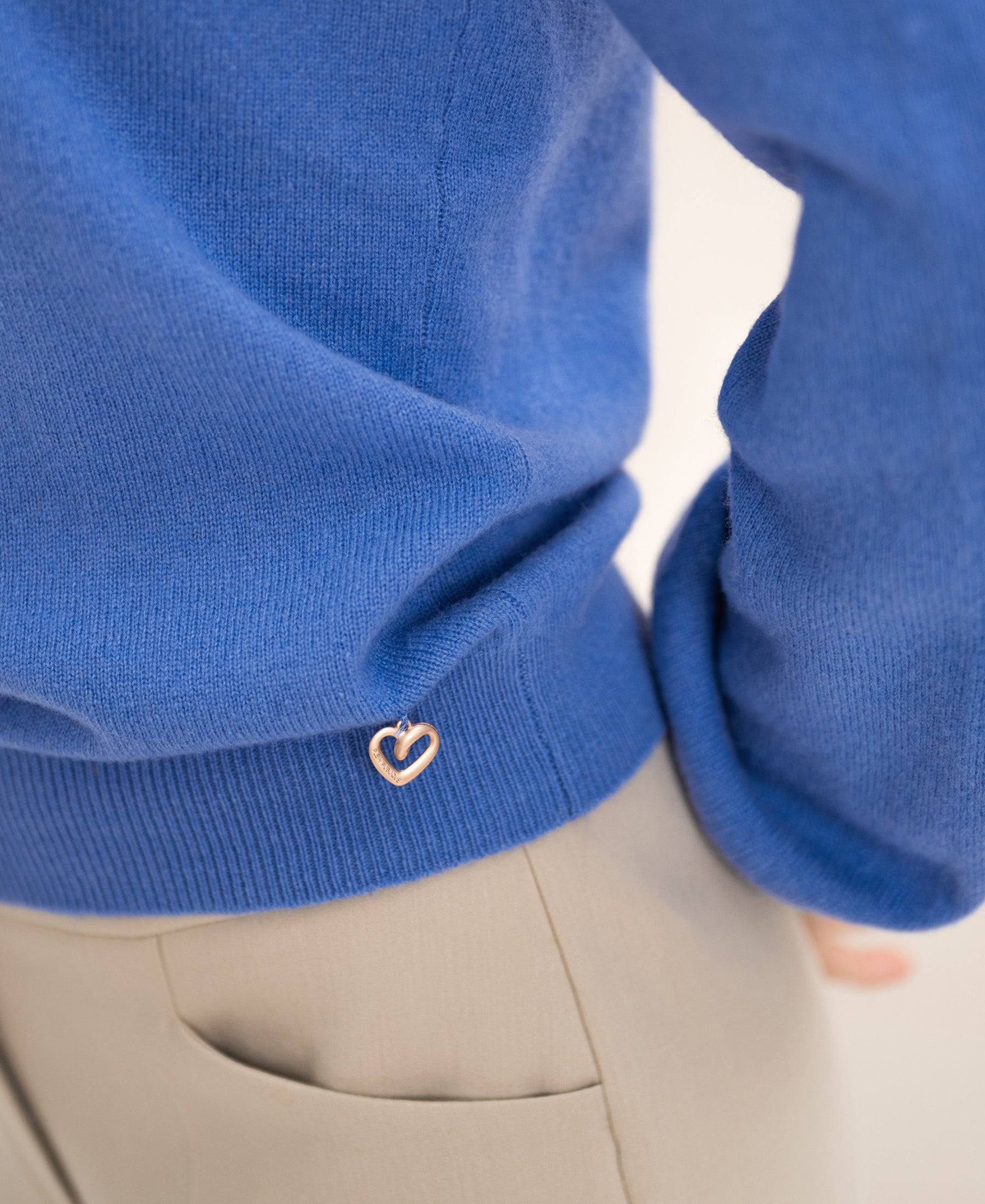 Blue PLEIN PUBLIQUE La Bayonne merino wool sweater with puff sleeves and heart-shaped pin.